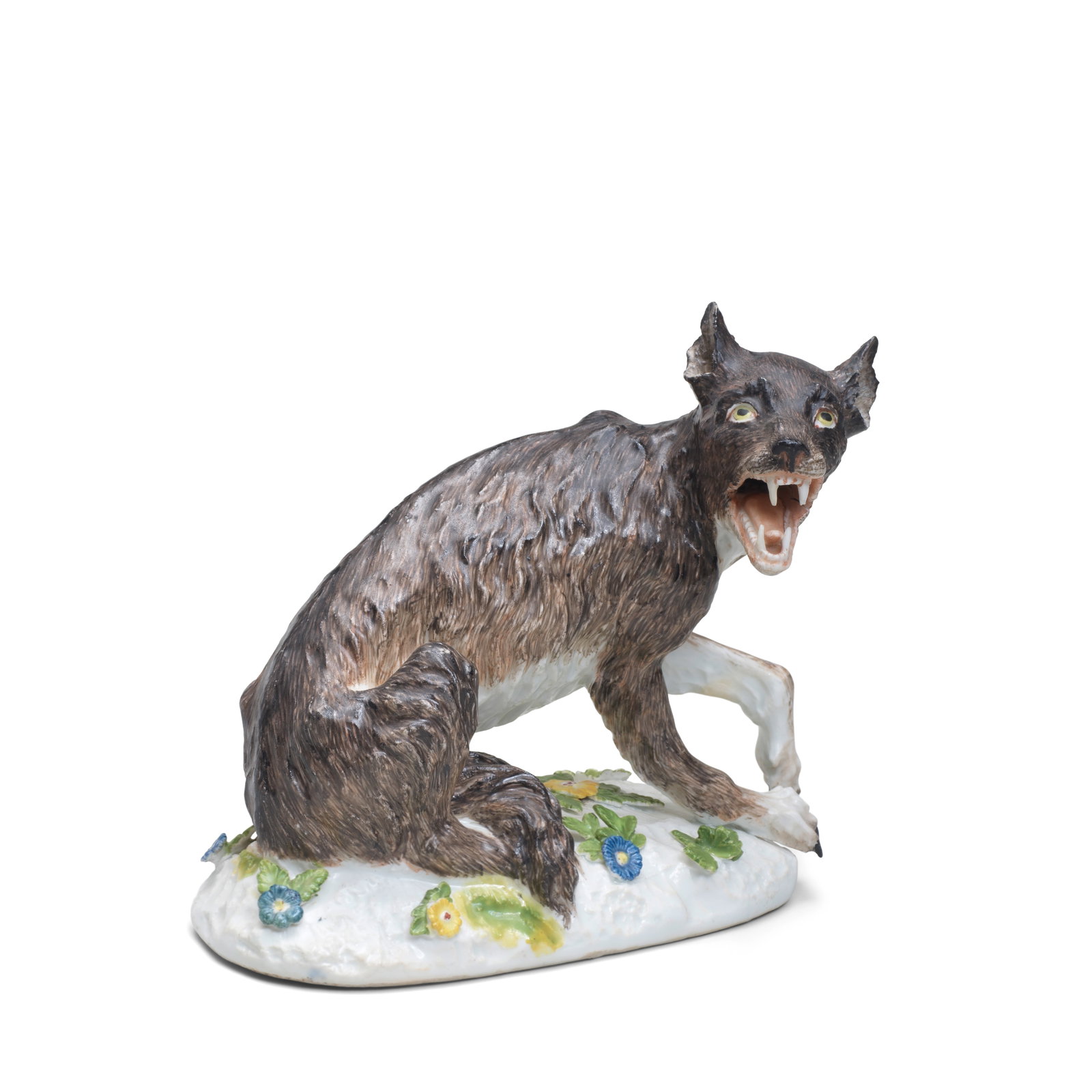A Meissen model of a wolf, circa 1745: A Meissen model of a wolf, circa 1745 Naturalistically modelled and coloured, with its head turned to its right, the base applied with leaves and flowers 14cm high; 16cm across, 'K.H.C.' in purple Foo