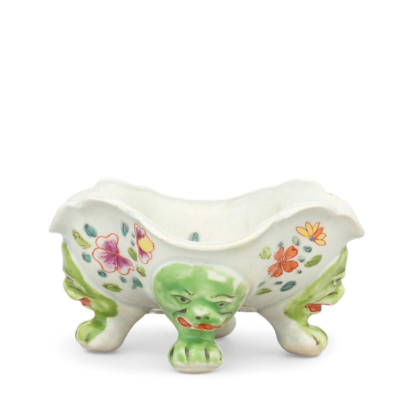 An exceptionally rare Limehouse salt, circa 1746-48: An exceptionally rare Limehouse salt, circa 1746-48 Of quatrelobed form with an undulating rim, raised on four bright green lion mask and paw feet, their mouths in red and features picked out in black