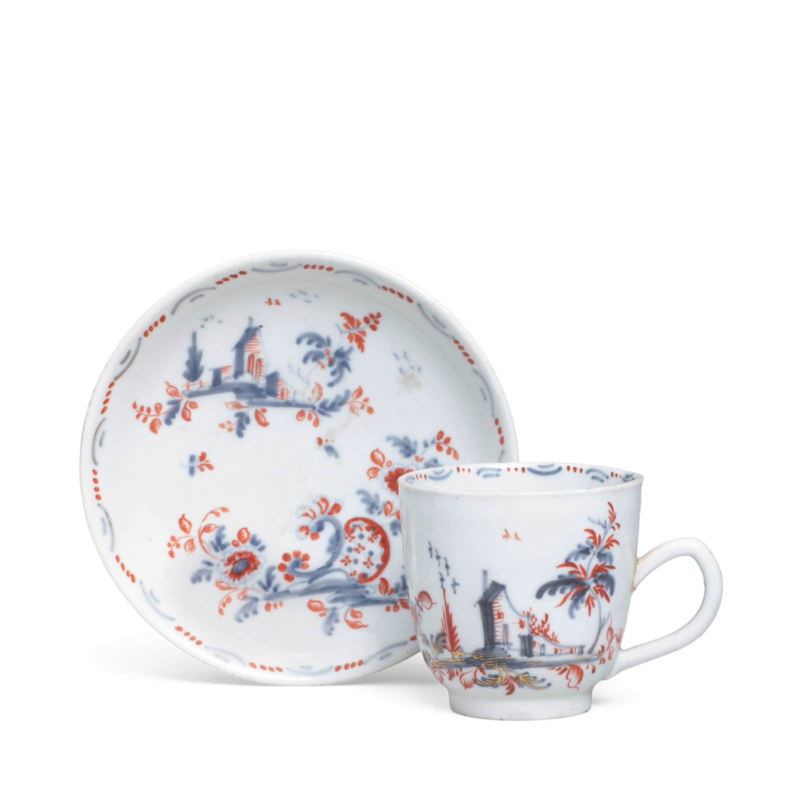 A Cozzi cup and saucer, circa 1775: A Cozzi cup and saucer, circa 1775 Painted in Imari style in underglaze-blue, iron-red and gilding, each with two vignettes with a building and a scrollwork trellis panel, respectively, edged with flo