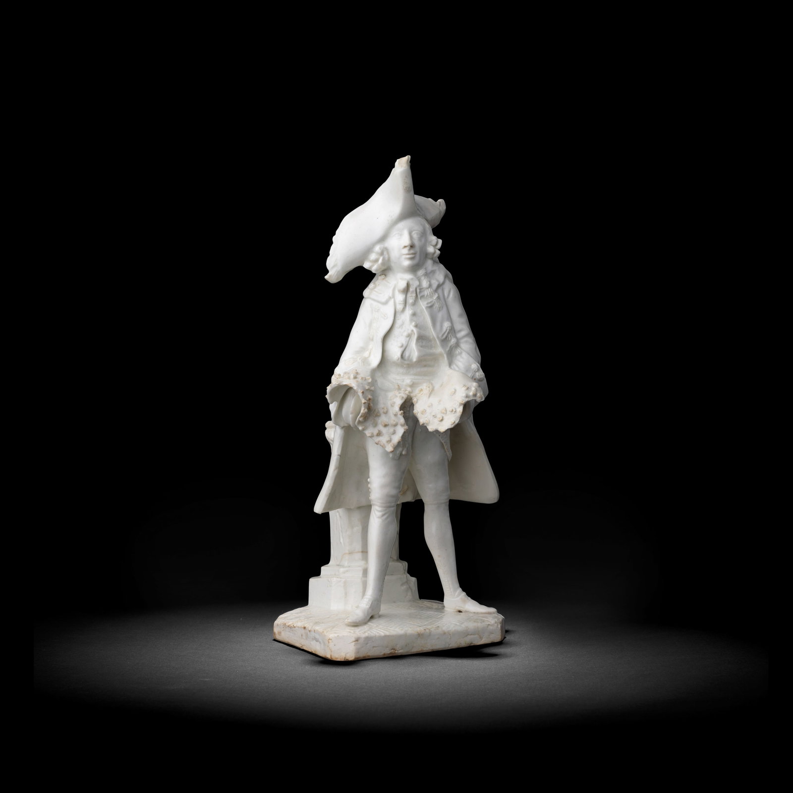 A rare Bow white figure of Henry Woodward, circa 1750: A rare Bow white figure of Henry Woodward, circa 1750 Modelled in the role of 'The Fine Gentleman' from Garrick's farce Lethe, wearing a large tricorn hat and frock coat above a lace-trimmed waistcoat