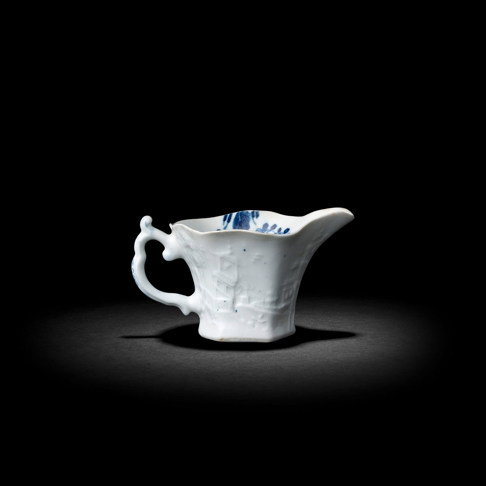 A Worcester 'Wigornia' creamboat, circa 1754: A Worcester 'Wigornia' creamboat, circa 1754 With the rare 'Moulding B', of hexagonal shape, the exterior embossed with a continuous Chinese landscape including on the front a curious tiered tree and 