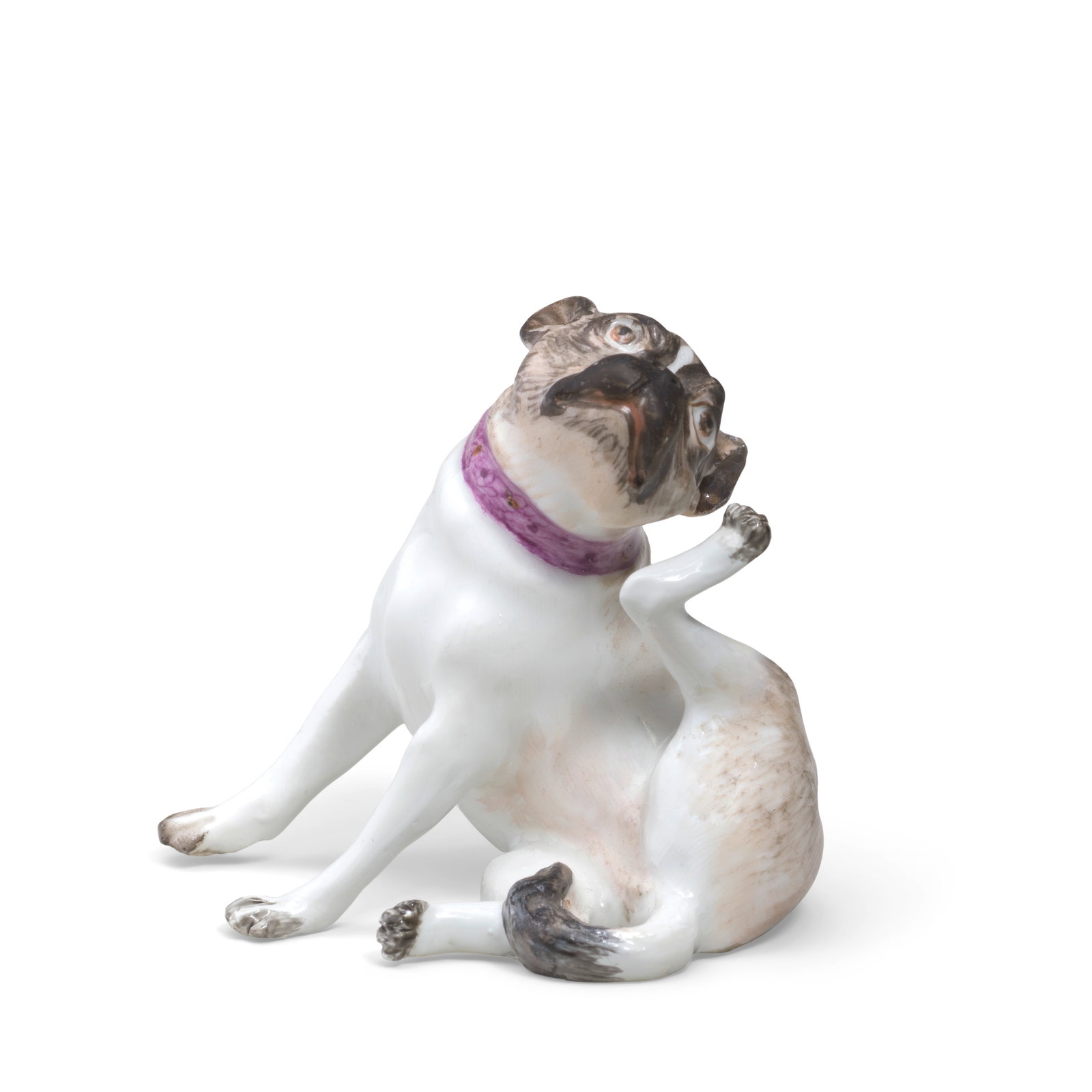 A Meissen miniature figure of a seated pug dog, circa 1745: A Meissen miniature figure of a seated pug dog, circa 1745 Modelled by J.J. Kaendler, seated and lifting its left leg to scratch its head, wearing a puce collar, naturalistically coloured in brown and