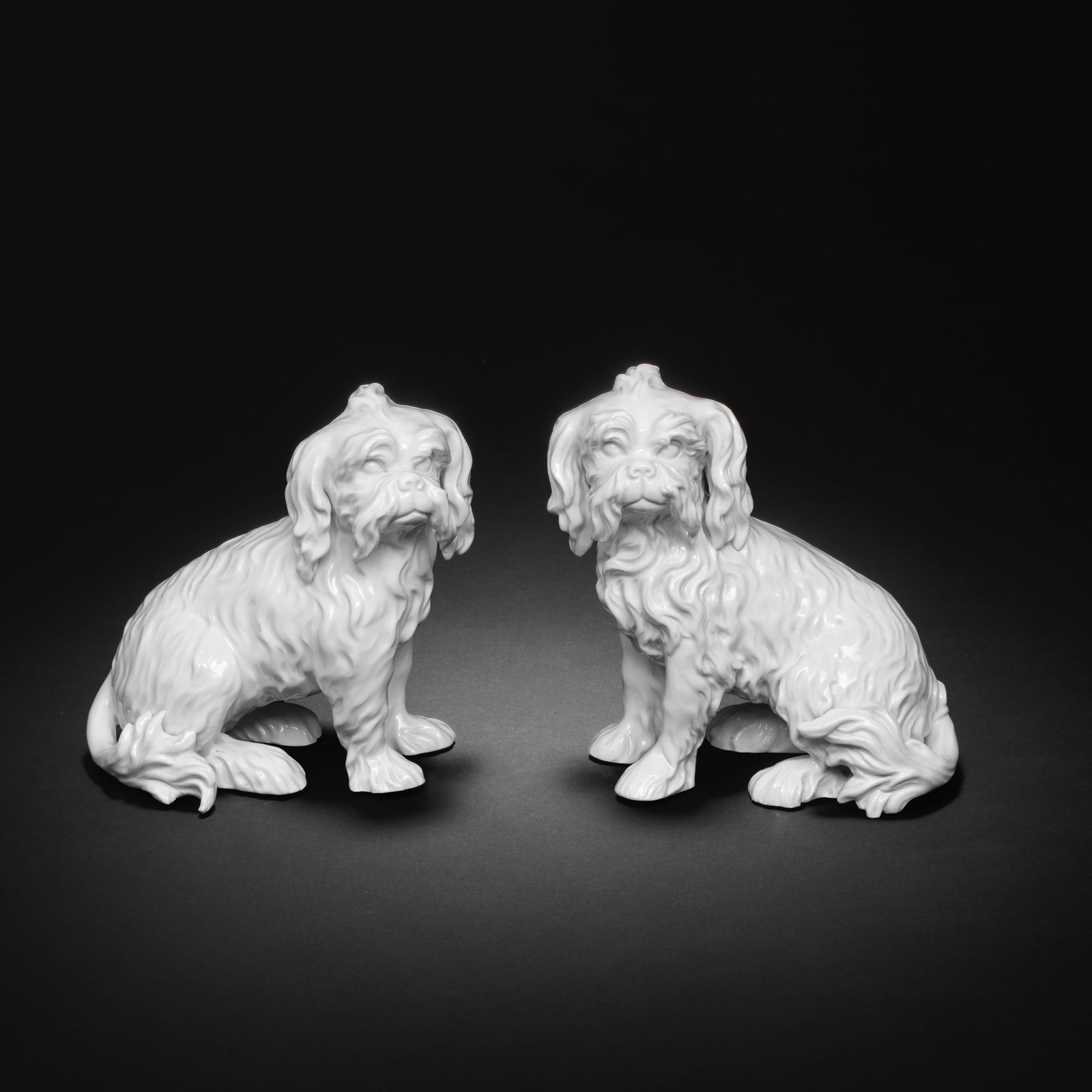 A rare pair of Frankenthal models of seated Bolognese hounds, circa 1765-77: A rare pair of Frankenthal models of seated Bolognese hounds, circa 1765-77 After the Meissen models by J.J. Kaendler, in the white, facing, each with its head turned to the front, 15.2cm and 16cm hig