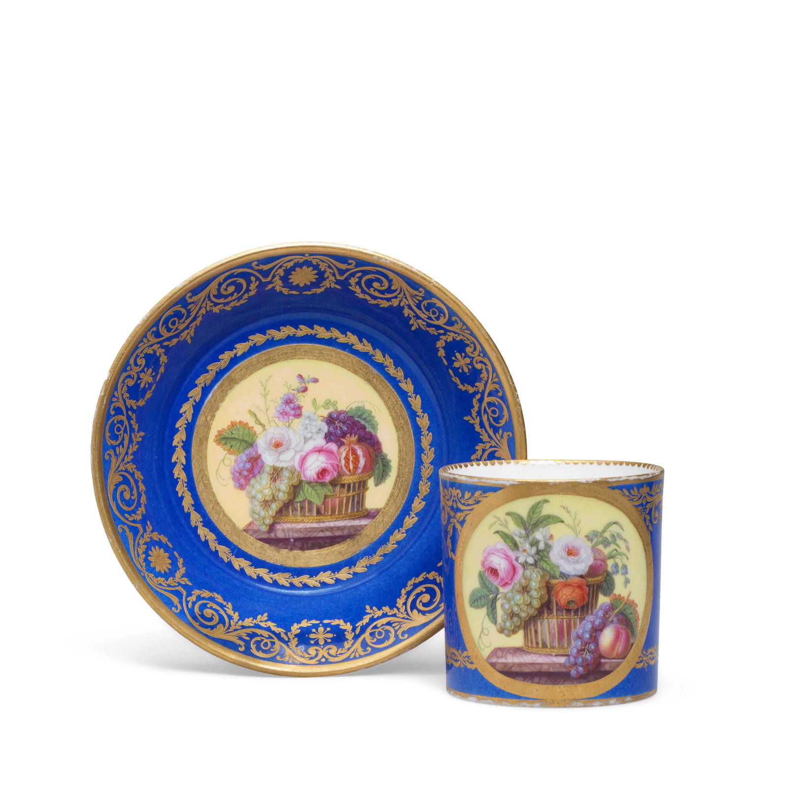 A Sèvres blue-ground cup and saucer (gobelet litron et soucoupe), dated 1787: A Sèvres blue-ground cup and saucer (gobelet litron et soucoupe), dated 1787 Of the first size, reserved with gilt edged yellow-ground panels enclosing still lifes of flowers and fruit in baskets