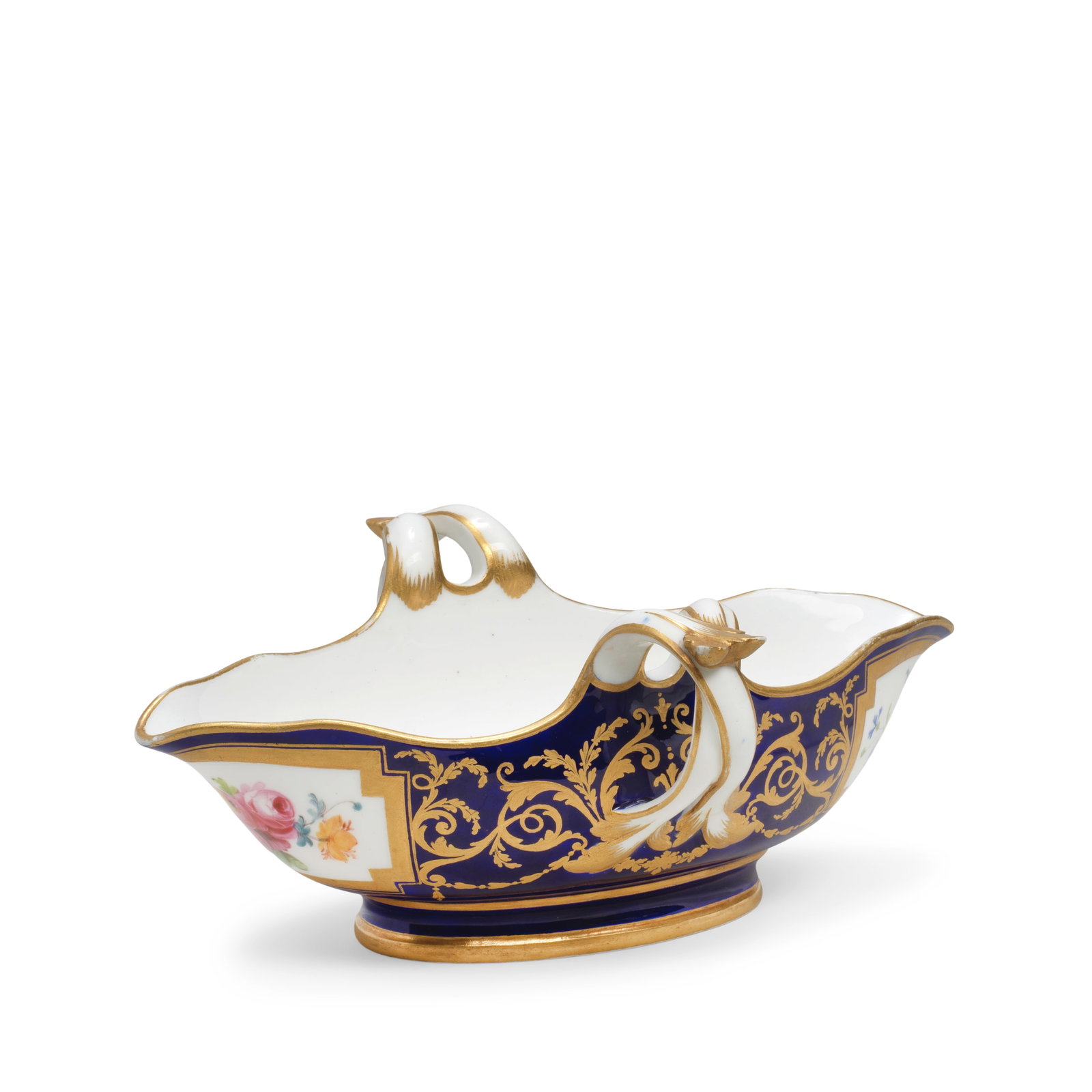 A Sèvres blue-ground sauceboat (saucière), dated 1786: A Sèvres blue-ground sauceboat (saucière), dated 1786 Decorated with gilt arabesque scrollwork against a beau bleu ground between cartouches painted with fruiting still lives on either end, 