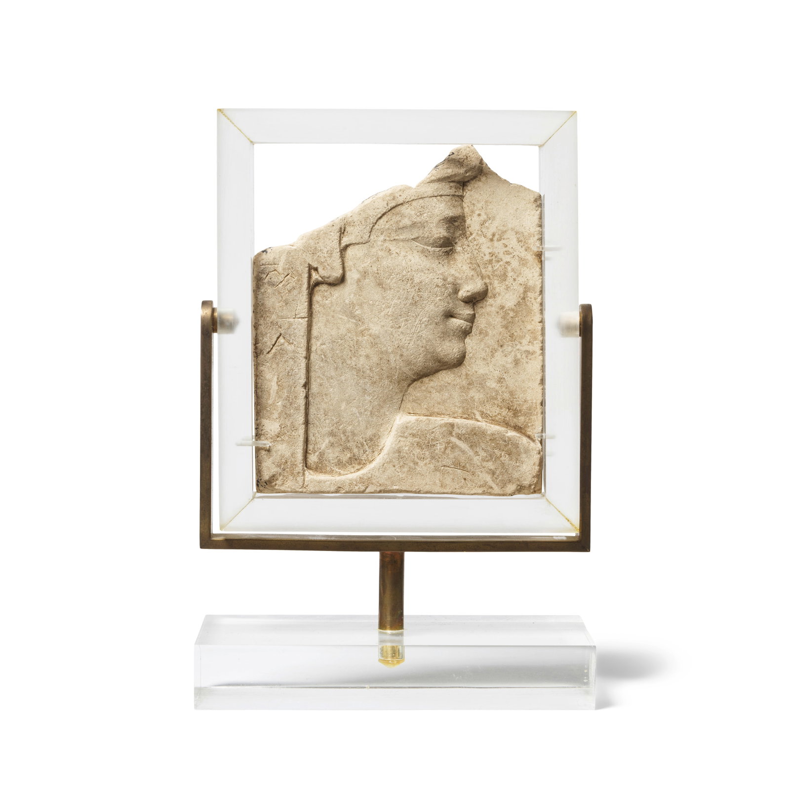 An Egyptian limestone double-sided sculptor's model relief with the head of a Pharaoh: An Egyptian limestone double-sided sculptor's model relief with the head of a Pharaoh Early Ptolemaic Period, circa 305-200 B.C. with two illegible markings on one side, possibly hieroglyphs, 13.3cm h