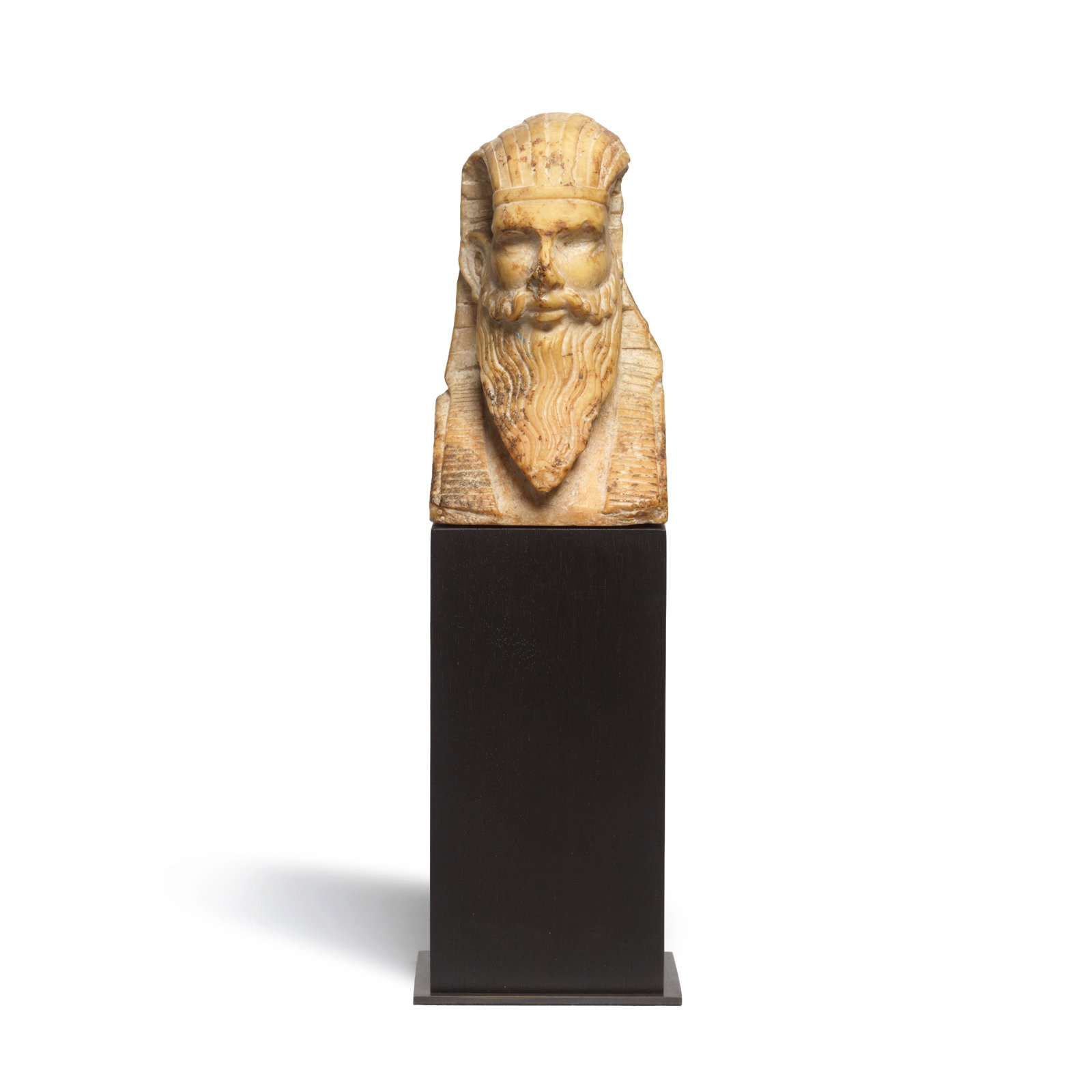 A Roman Egyptianizing giallo antico bust of a bearded deity: A Roman Egyptianizing giallo antico bust of a bearded deity Circa 1st-2nd Century A.D. 11cm high Footnotes: Provenance: Ivan and Marianne Mirošević-Sorgo collection, UK. Mirošević-