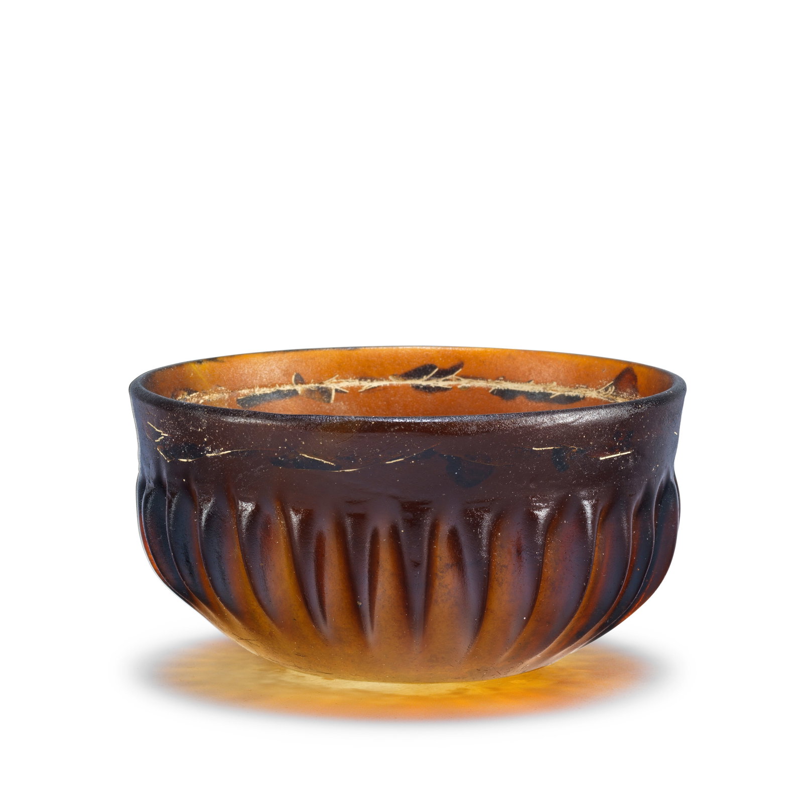 A Roman amber glass ribbed bowl: A Roman amber glass ribbed bowl Circa late 1st Century B.C. - mid-1st Century A.D. 12.2cm diam., 6.5cm high Footnotes: Provenance: with Marvin Kagan Art, Inc., New York. Schefler Collection, New York,