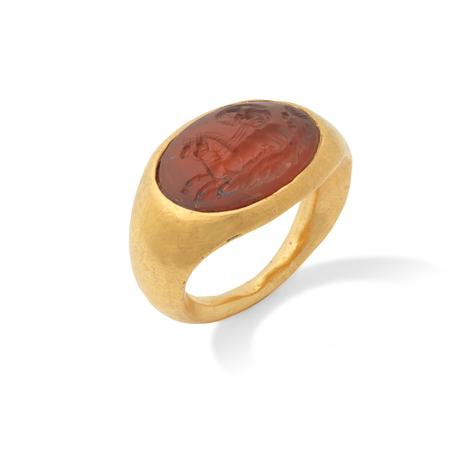 A Roman gold and carnelian ring, with a Nereid and a biga drawn by hippocamps: A Roman gold and carnelian ring, with a Nereid and a biga drawn by hippocamps Circa 1st-2nd Century A.D. ring size I, the intaglio 2cm long, weight 7.4g Footnotes: Provenance: Property of French priva