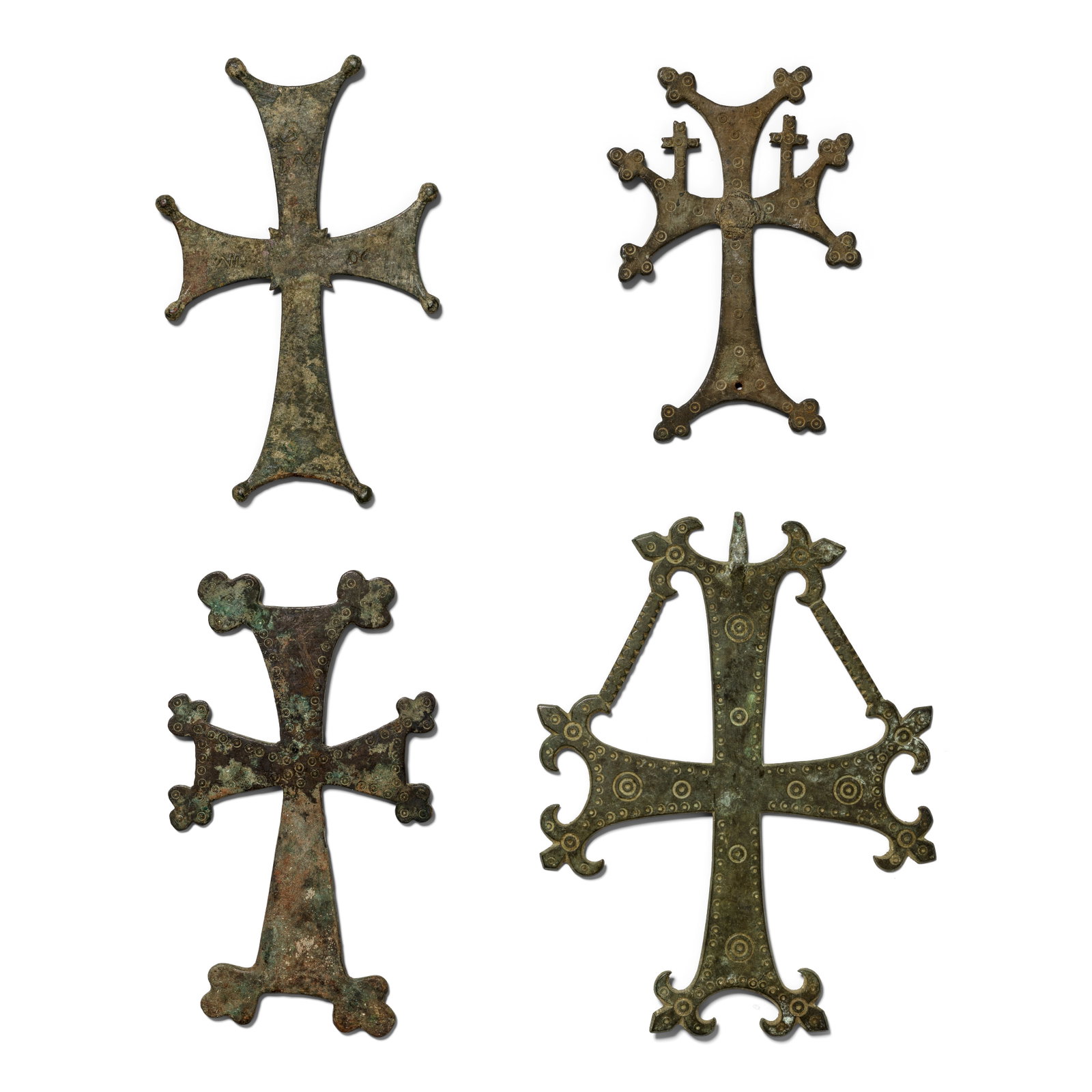 Four Byzantine bronze crosses 4: Four Byzantine bronze crosses Circa 6th-11th Century A.D. Including a processional cross with branches representing the tree of life, and another cross with Greek inscription, 14.5cm-20.5cm high (4) F