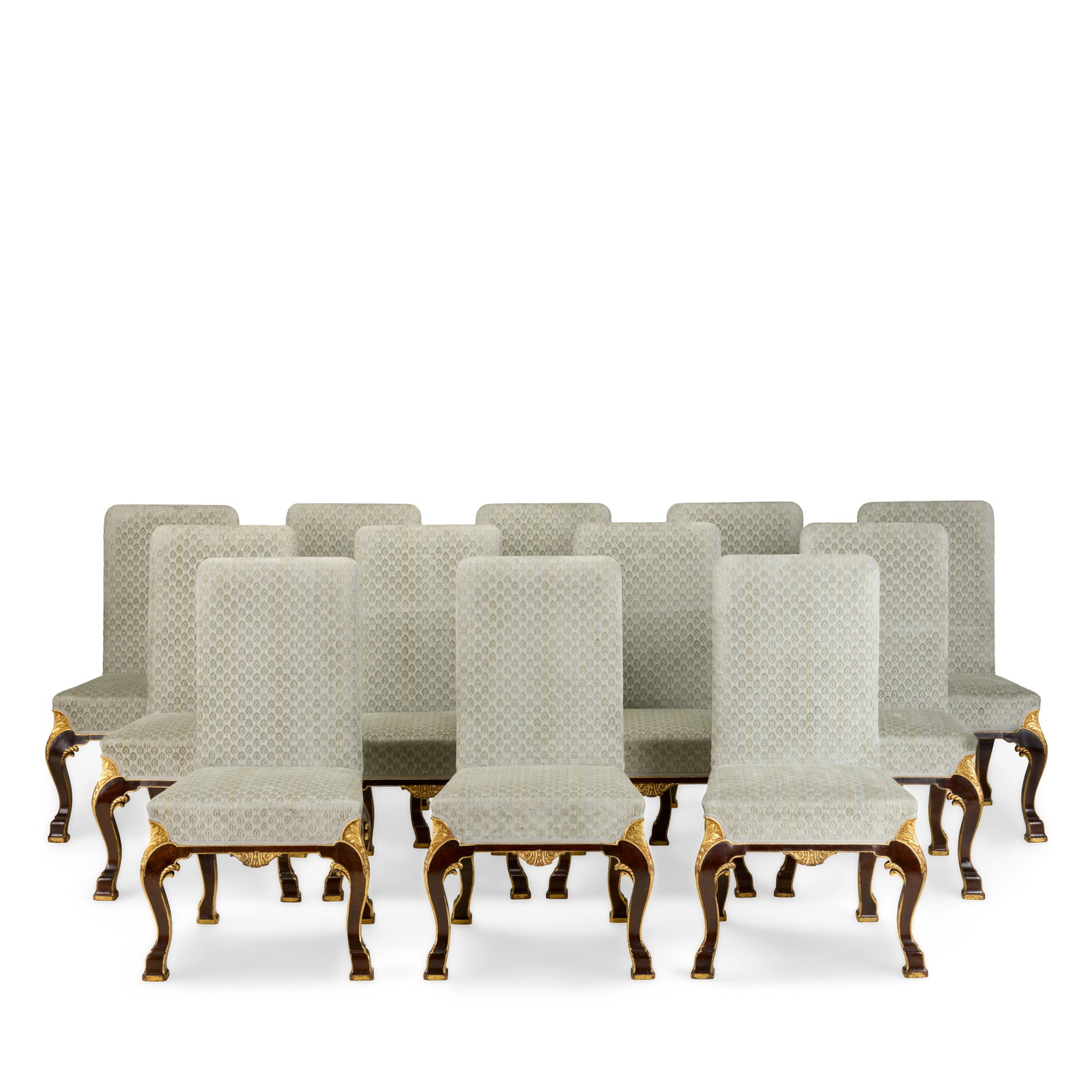 A set of twelve early 20th century walnut and parcel gilt side chairs after the renowned Houghto...: A set of twelve early 20th century walnut and parcel gilt side chairs after the renowned Houghton Hall model 1910-1930, in the George I style Each on square section scroll eared and part gadrooned cab