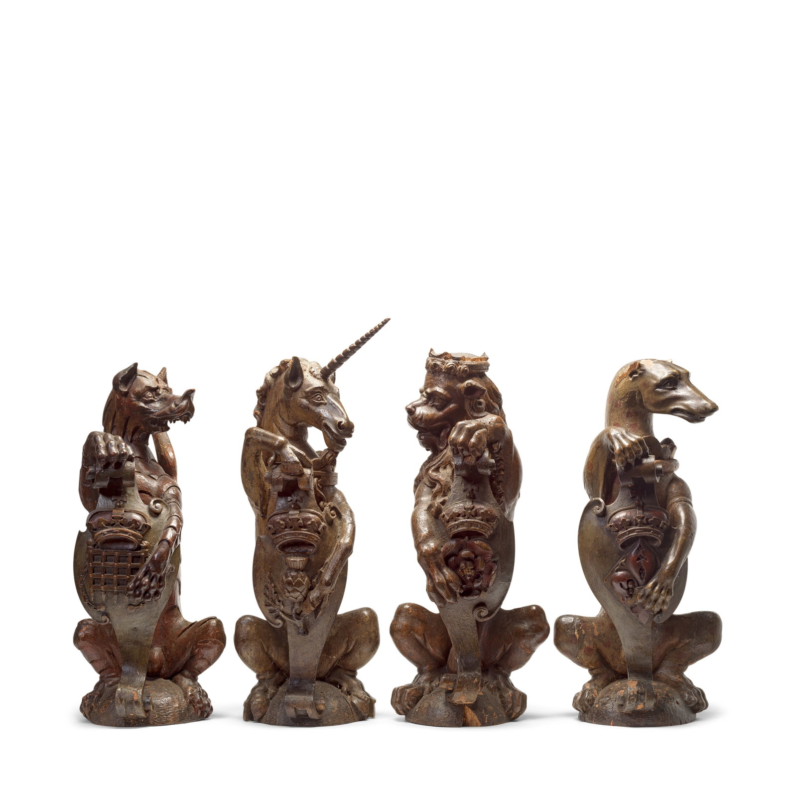 A rare and important set of four English carved oak heraldic newel post finial beasts representi... (1 of 1)