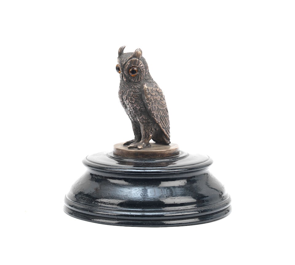 An Owl mascot by Varnier, French, 1920s,: An Owl mascot by Varnier, French, 1920s, signed, nickel plated bronze with glass eyes, 9cm high, on a black painted turned wooden base. Lot to be sold without reserve. For further information on this 