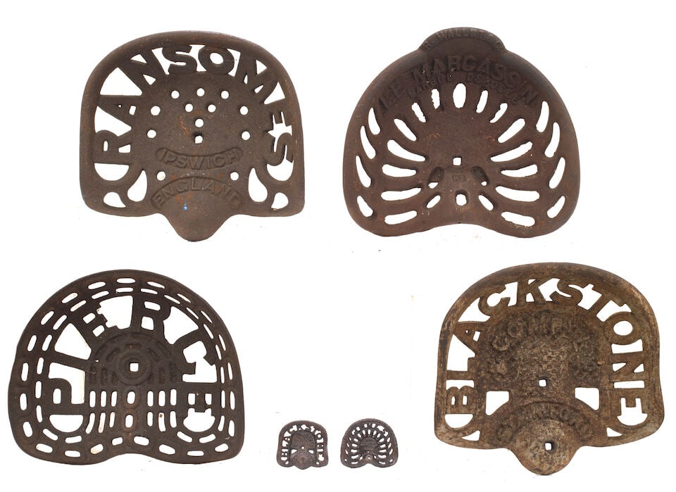 Four cast-iron tractor seats, ((6)): Four cast-iron tractor seats, comprising Ransomes model A237, Blackstone model 389, Pierce model M103 and R. Wallut & Cie 'Le Marcassin' model M2, (used); together with two salesman's samples of seats