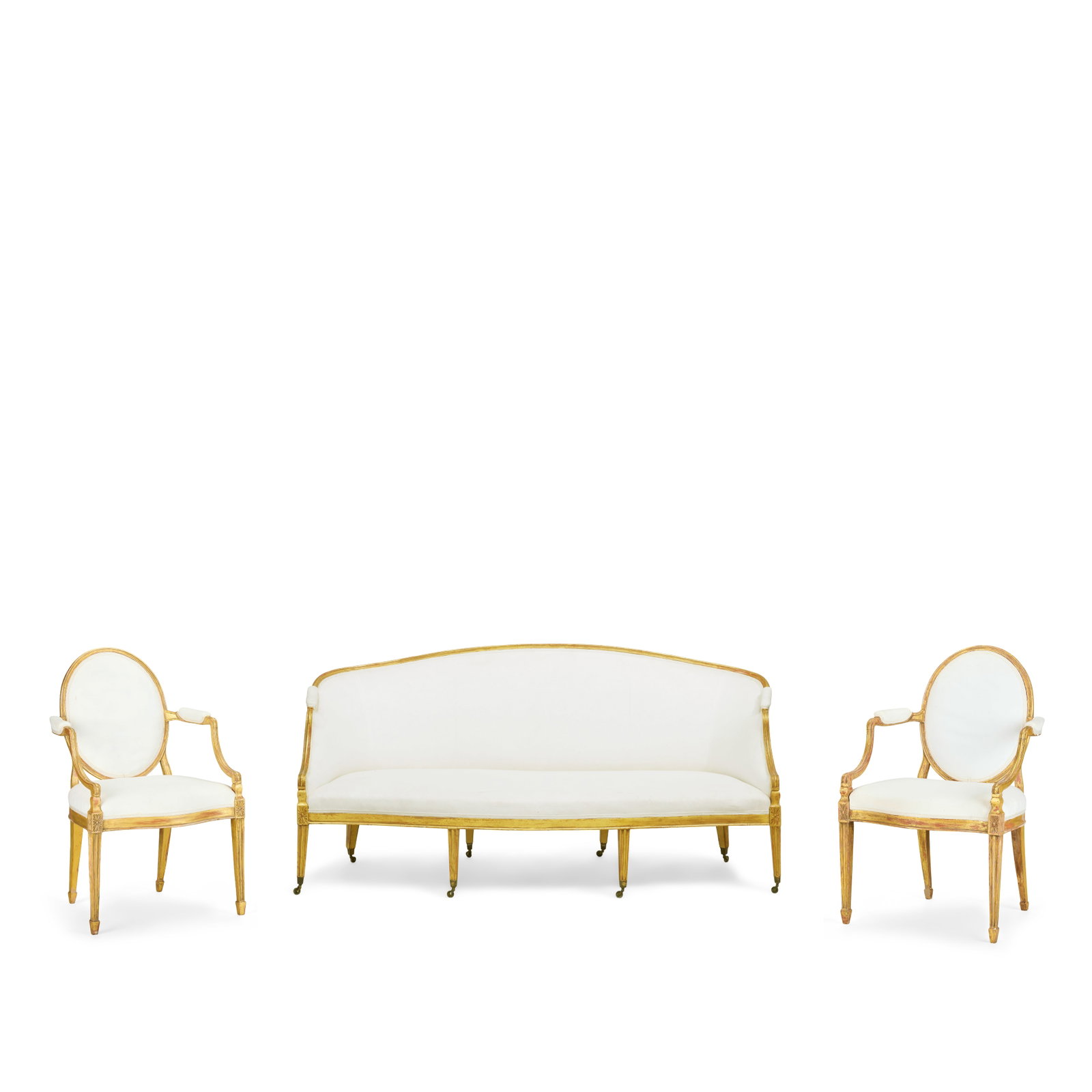 The Myrton Castle Suite: A George III carved giltwood suite to include a pair of sofas and a pai...: The Myrton Castle Suite: A George III carved giltwood suite to include a pair of sofas and a pair of armchairs In the manner of John Linnell (1729-1796) The curved moulded top rail above scrolling arm
