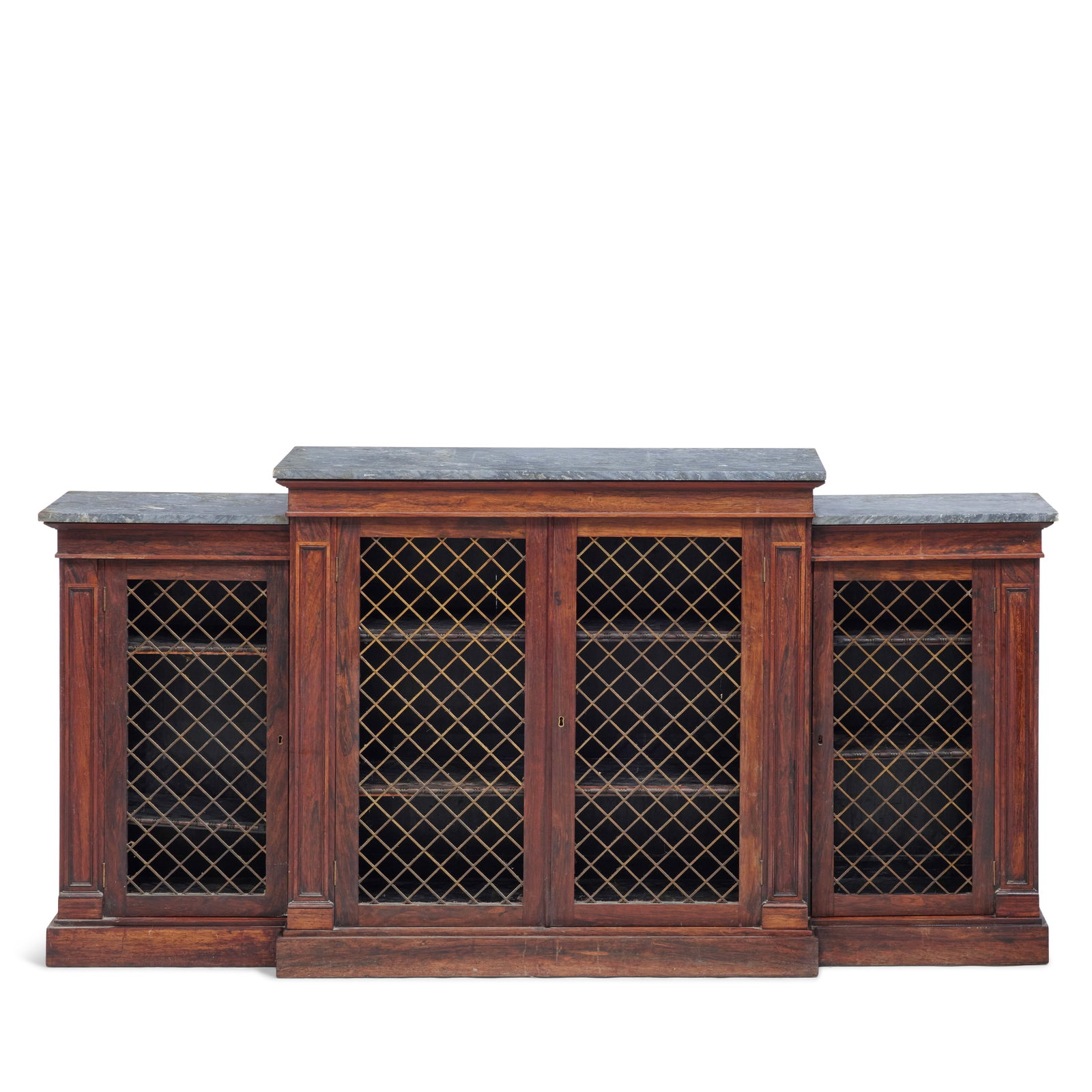A William IV rosewood breakfront dwarf bookcaseEarly 19th century, in the manner of Gillows: A William IV rosewood breakfront dwarf bookcase Early 19th century, in the manner of Gillows The marble tops above four gilt-brass lattice panelled doors enclosing adjustable shelves flanked by panell
