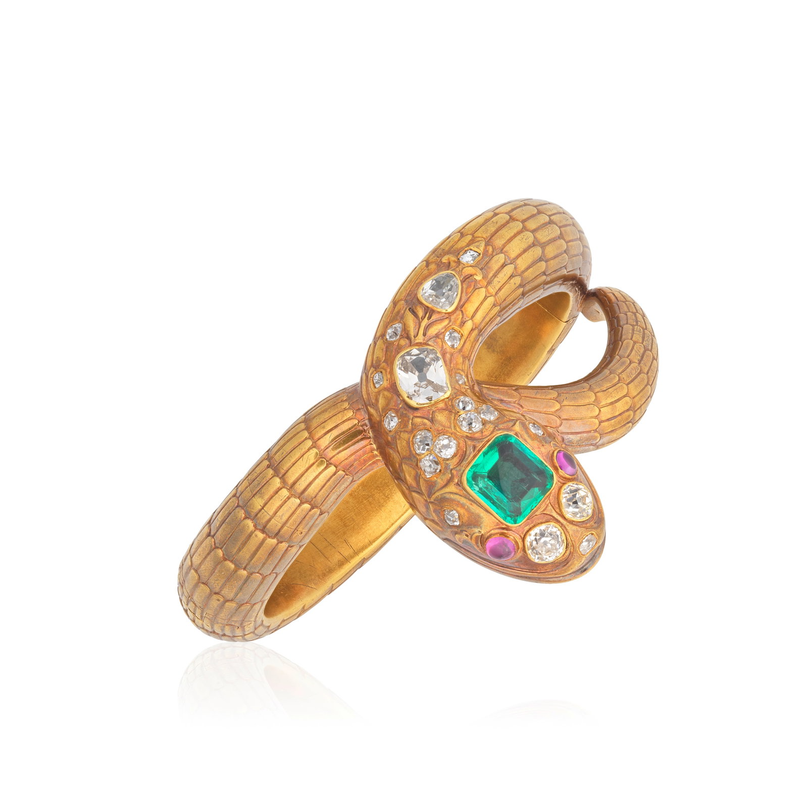 EMERALD, DIAMOND AND RUBY-SET SNAKE BANGLE, LATE 19TH CENTURY: EMERALD, DIAMOND AND RUBY-SET SNAKE BANGLE, LATE 19TH CENTURY Designed as a serpent with chased detailing, the head set with a step-cut emerald, accented by old cushion-cut diamonds, the eyes set with