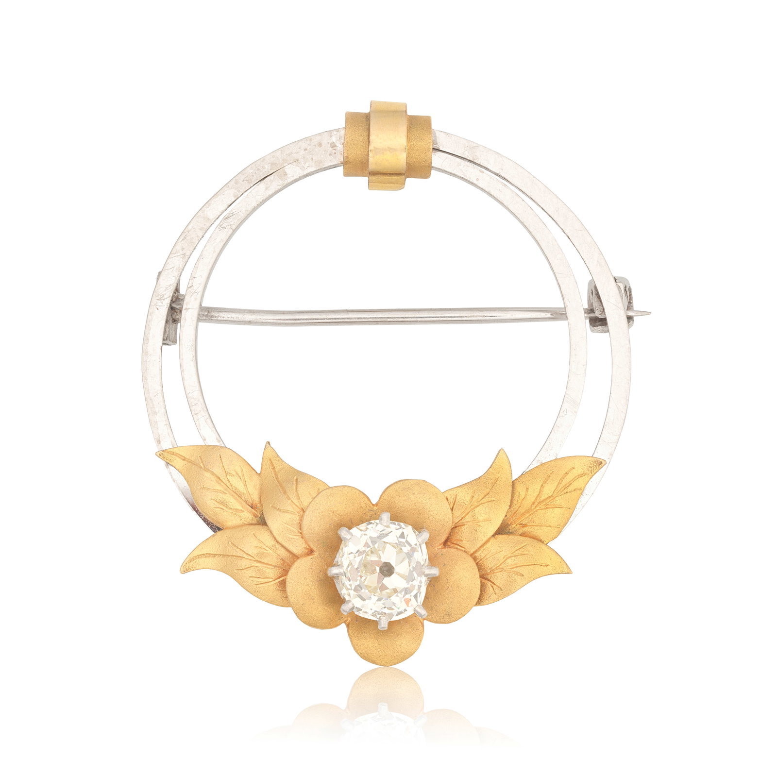 DIAMOND-SET BROOCH, CIRCA 1900: DIAMOND-SET BROOCH, CIRCA 1900 Of circular design, accented by a flower within a foliate surround, centred by an old cushion-cut diamond, diamond approx. 1.30cts, length 3.6cm, cased by T. Smith & Son