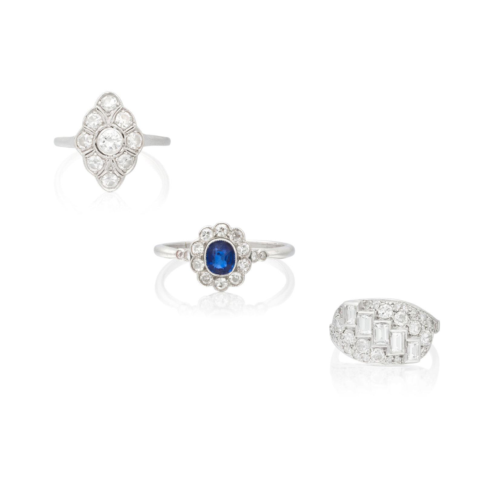 THREE DIAMOND-SET RINGS: THREE DIAMOND-SET RINGS 1st: Set with baguette, old brilliant and single-cut diamonds, 2nd: The oval-cut sapphire to a scalloped edge border of old single-cut diamonds, 3rd: The stylised lozenge-shape