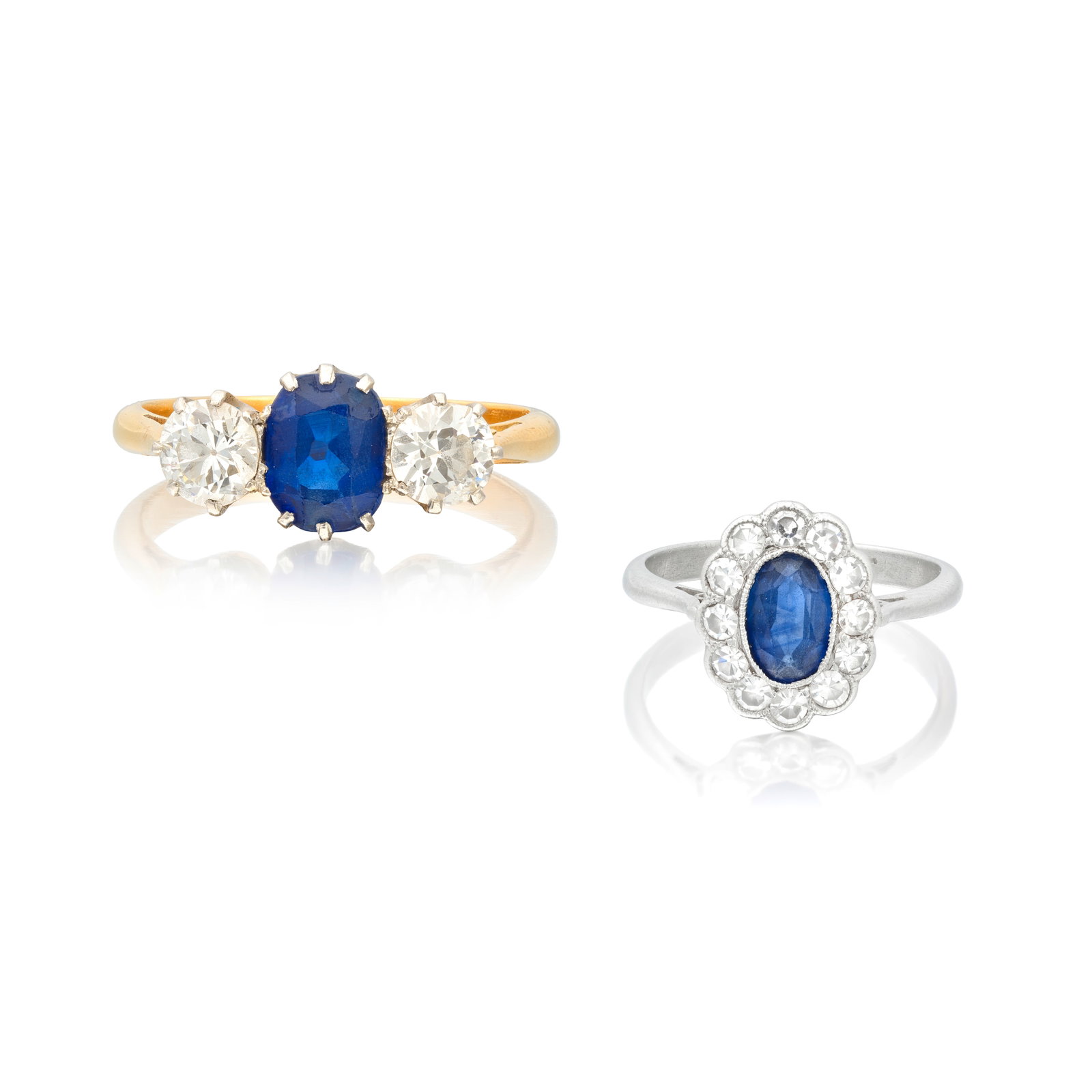TWO SAPPHIRE AND DIAMOND RINGS (2): TWO SAPPHIRE AND DIAMOND RINGS 1st: The oval-cut sapphire between old brilliant-cut diamonds, 2nd: The oval-cut sapphire to a scalloped edge border of single-cut diamonds, 1st: ring size approx. N, 2n