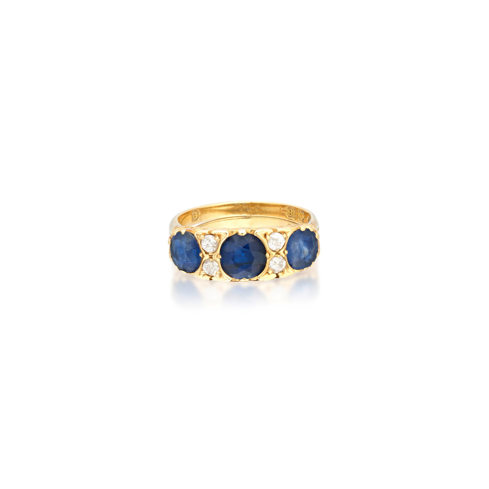 SAPPHIRE AND DIAMOND RING, CIRCA 1900: SAPPHIRE AND DIAMOND RING, CIRCA 1900 The cushion-cut sapphires between duos of old brilliant-cut diamonds, to a carved scroll gallery, mounted in gold, partial UK hallmark, ring size approx. P½ 