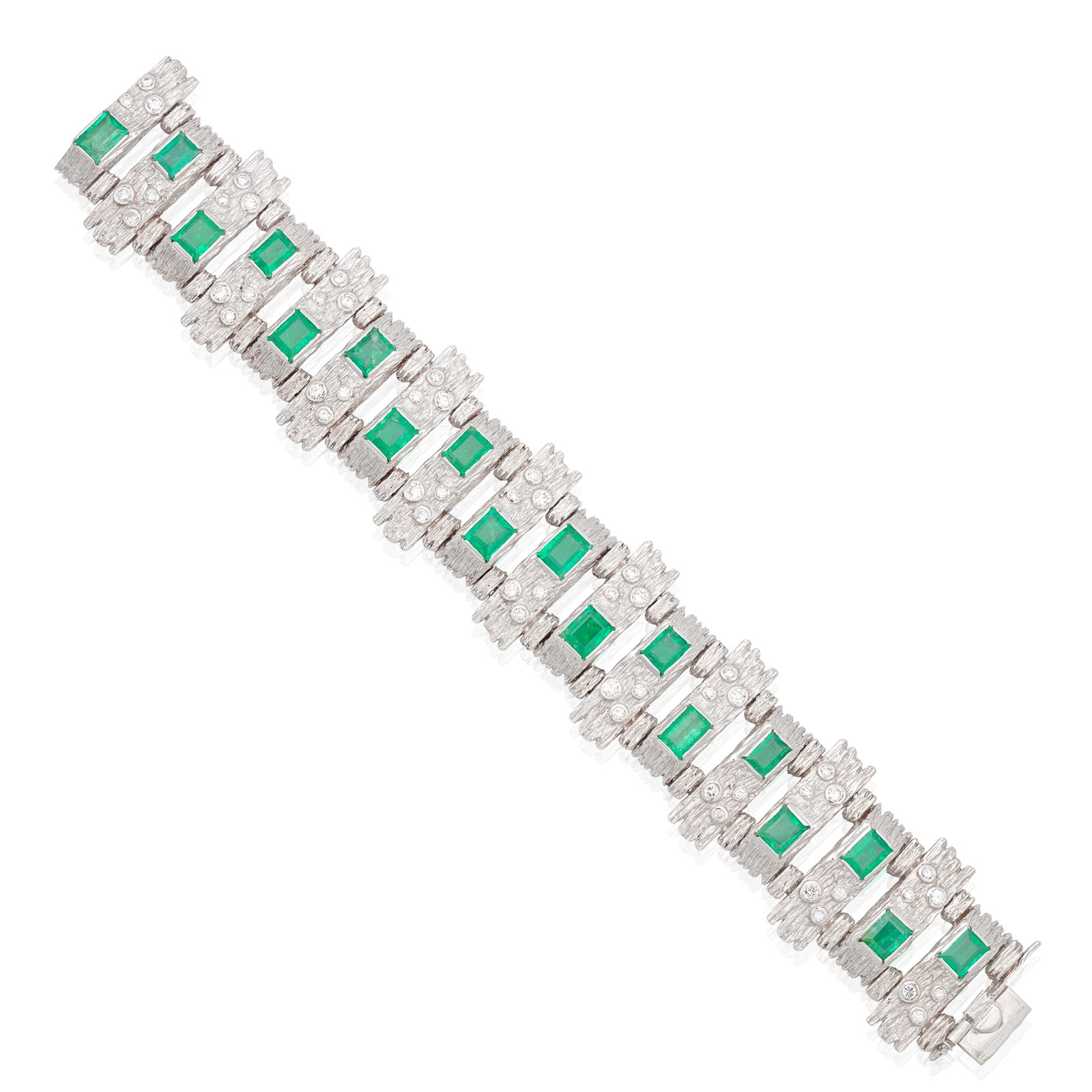 EMERALD AND DIAMOND BRACELET, 1972: EMERALD AND DIAMOND BRACELET, 1972 The textured 18 carat white gold batons accented by step-cut emeralds and brilliant-cut diamonds, maker's mark GD, London hallmark, length 17.1cm, cased by The Golds