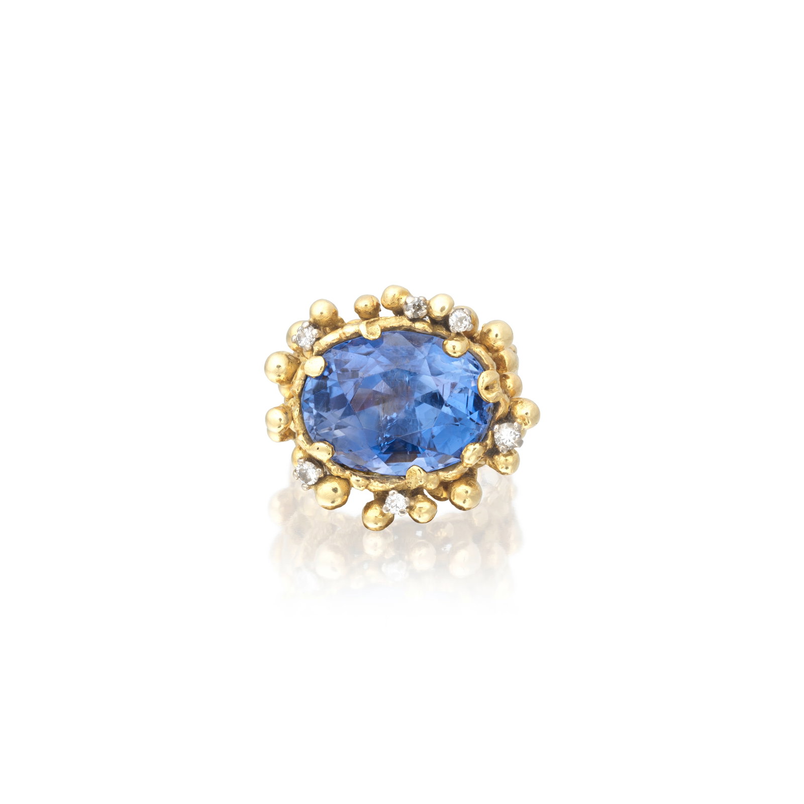 JOHN DONALD: SAPPHIRE AND DIAMOND RING, 1971: JOHN DONALD: SAPPHIRE AND DIAMOND RING, 1971 The oval-cut sapphire set within an 18 carat gold textured mount, accented by brilliant-cut diamonds, signed JAD, London hallmark, sapphire approx. 14.75ct