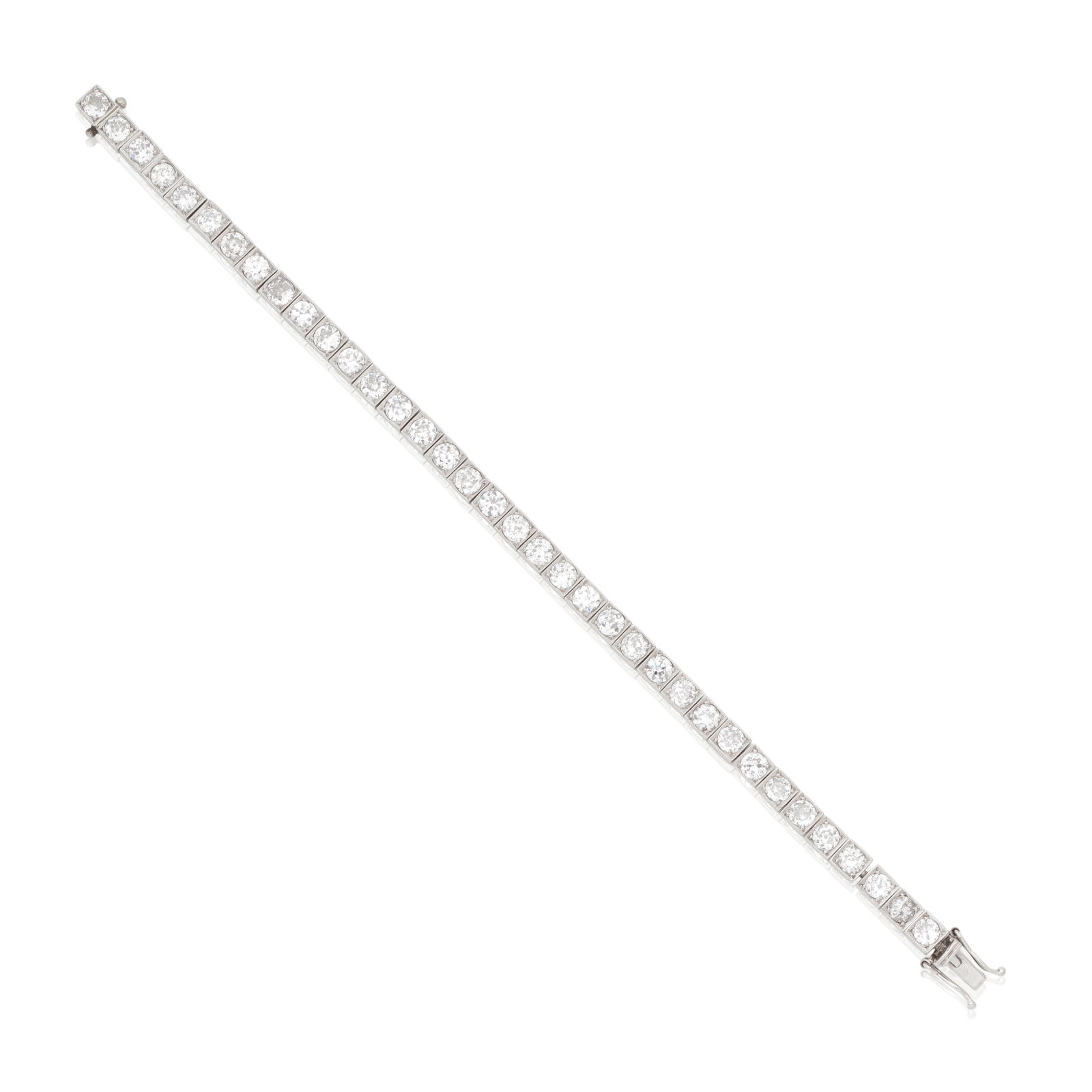 DIAMOND LINE BRACELET, CIRCA 1915: DIAMOND LINE BRACELET, CIRCA 1915 Set throughout with old brilliant-cut diamonds in box-link settings with carved scroll engraving to galleries, mounted in platinum, diamonds approx. 9.00cts total,