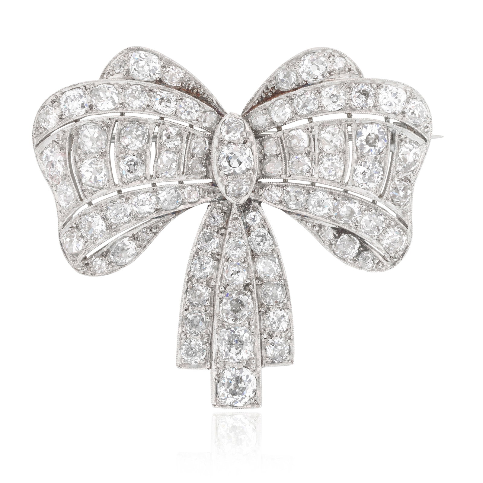 DIAMOND BOW BROOCH, CIRCA 1925: DIAMOND BOW BROOCH, CIRCA 1925 Of pierced bombé form, set throughout with old cushion-cut diamonds, millegrain-set in platinum, diamonds approx. 6.00cts total, length 4.9cm For further informatio
