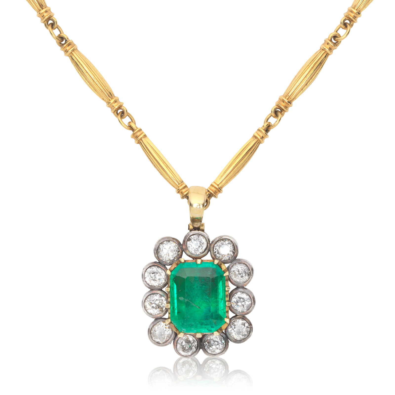 EMERALD AND DIAMOND CLUSTER PENDANT/NECKLACE: EMERALD AND DIAMOND CLUSTER PENDANT/NECKLACE The octagonal step-cut emerald weighing 6.29 carats, within a surround of old brilliant-cut diamonds, suspended from a fancy-link chain, diamonds approx. 3