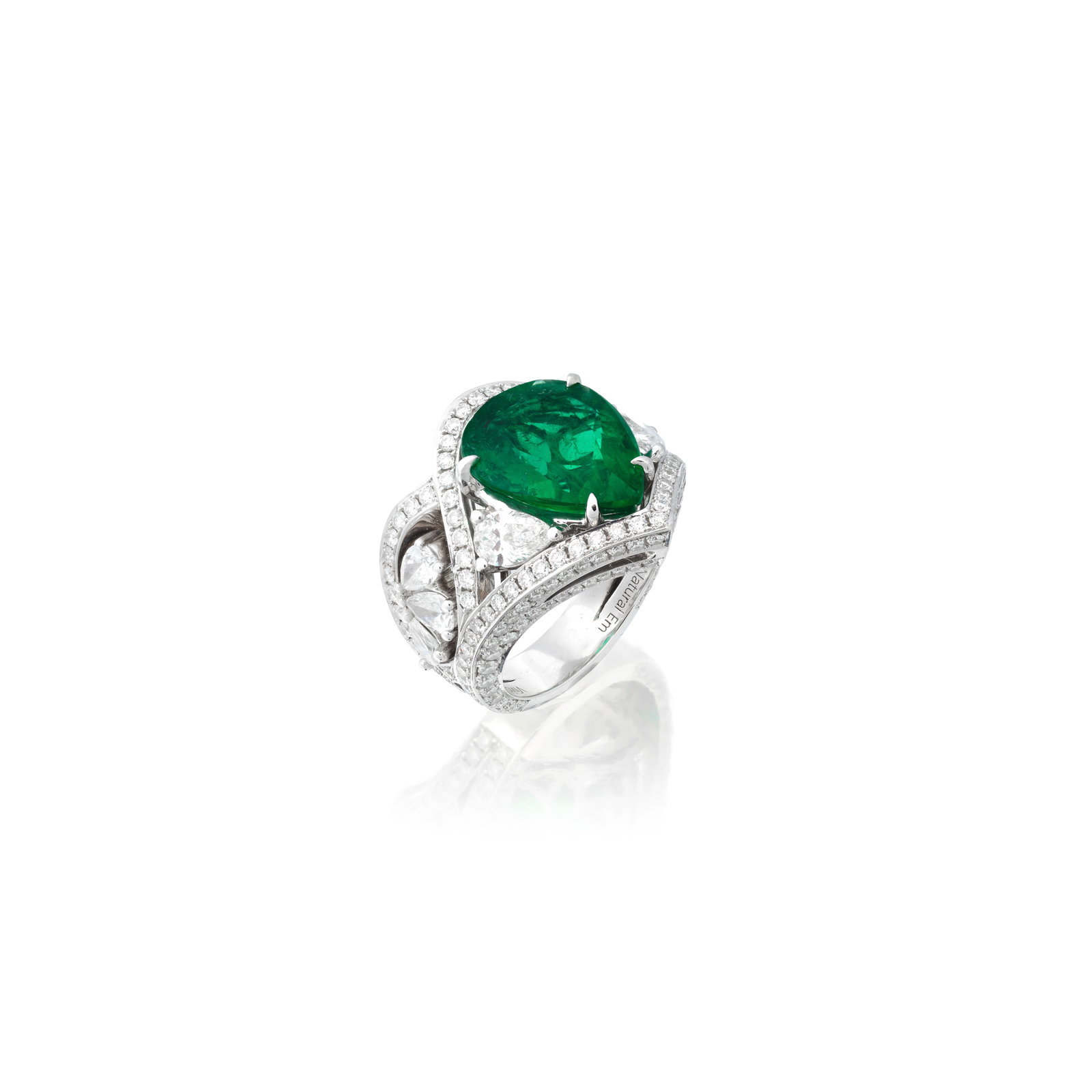 EMERALD AND DIAMOND RING: EMERALD AND DIAMOND RING The pear-shaped emerald set between similarly-cut diamonds, within a surround of brilliant-cut diamonds, the shoulders each set with a trio of pear-shaped diamonds in a fan-li