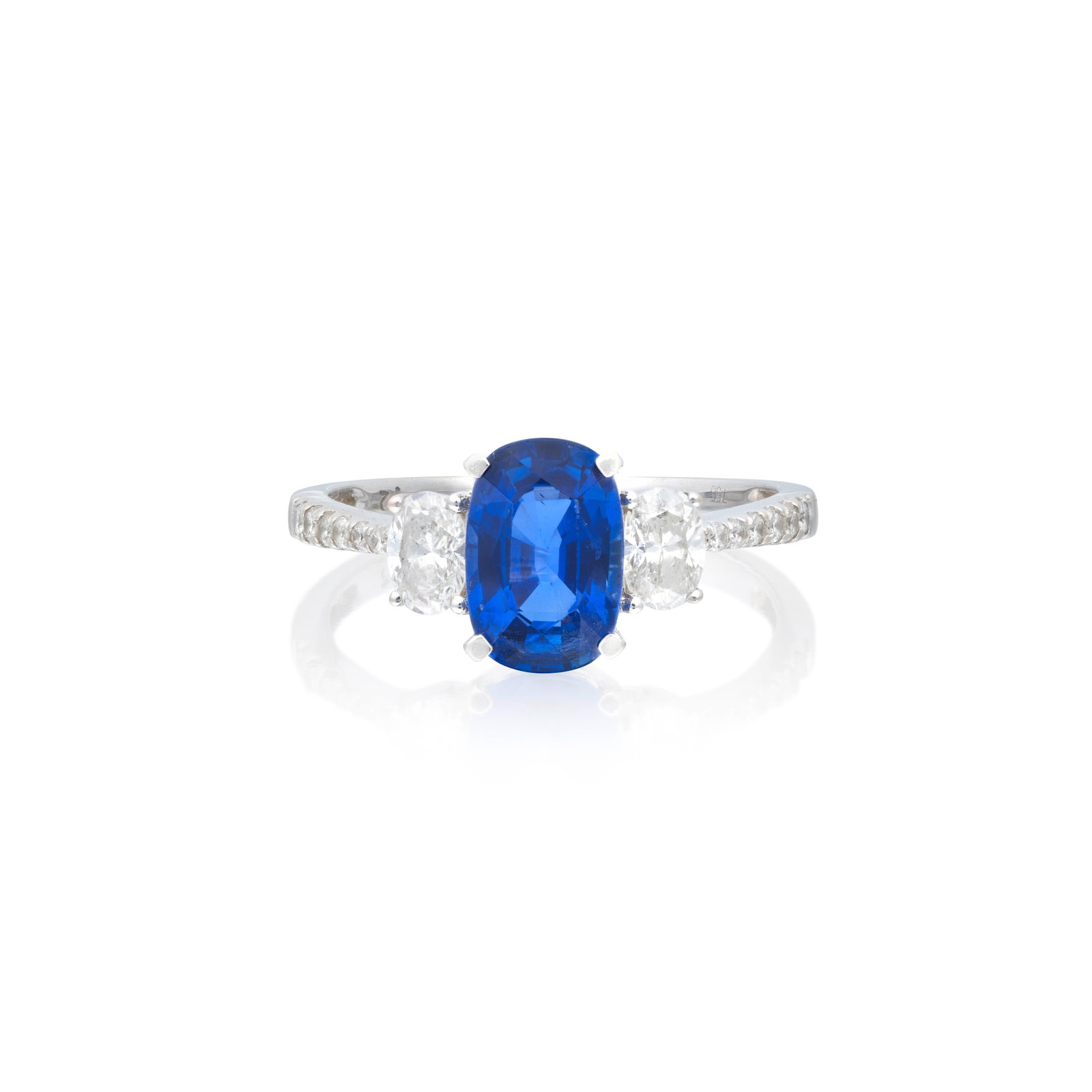SAPPHIRE AND DIAMOND RING: SAPPHIRE AND DIAMOND RING The oval-cut sapphire between oval-cut diamonds, to shoulders set with brilliant-cut diamonds, ring size approx. P½ For further information on this lot please visit Bonh
