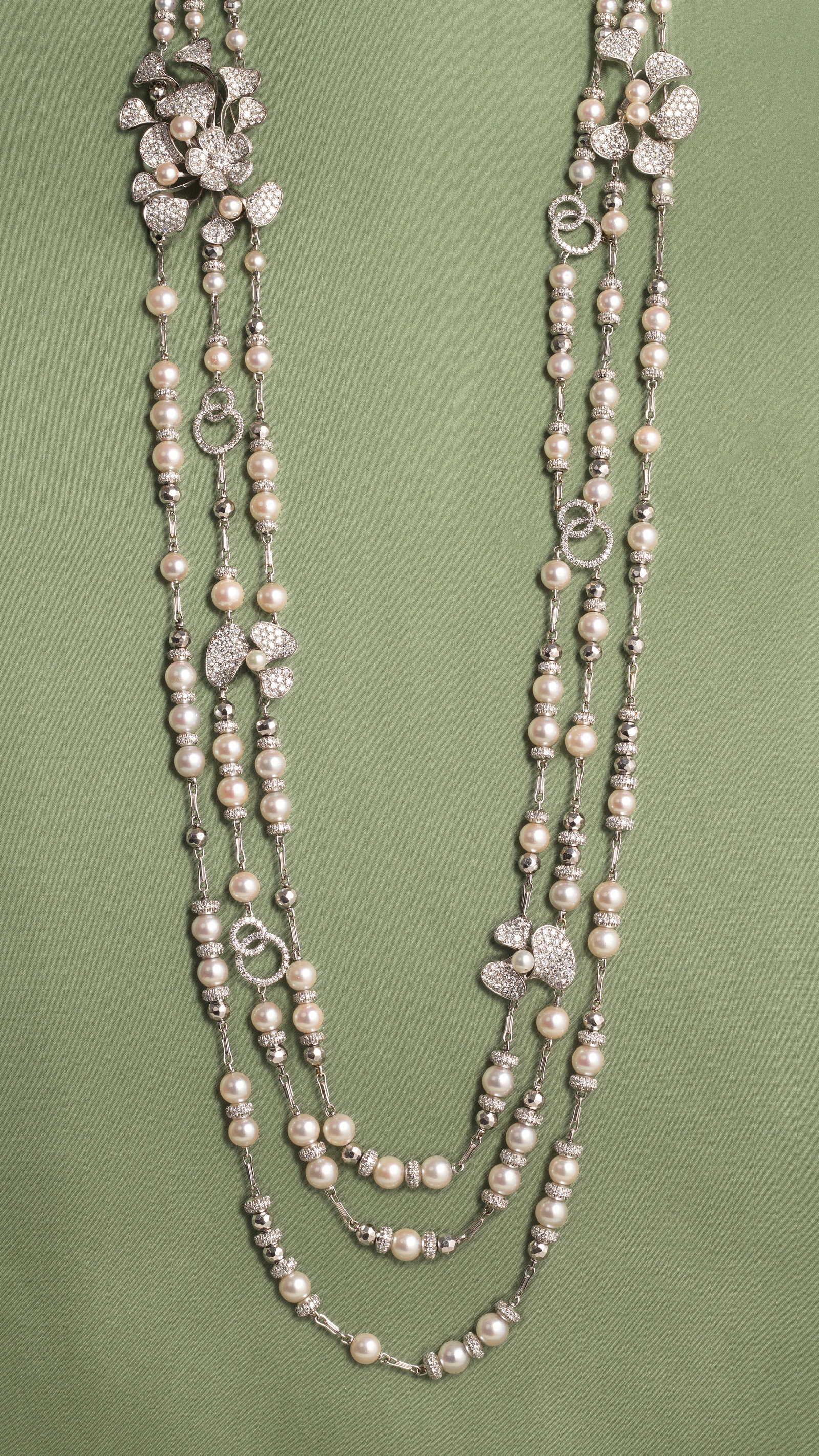 DAVID MORRIS: CULTURED PEARL AND DIAMOND NECKLACE: DAVID MORRIS: CULTURED PEARL AND DIAMOND NECKLACE Designed as three rows of cultured pearls between diamond-set rondelle spacers, accented by flowers and interlocking hoops of pavé-set single-cut