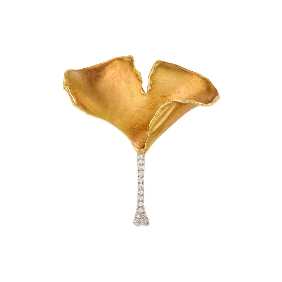TIFFANY & CO.: 18K YELLOW GOLD, PLATINUM, AND DIAMOND BROOCH: TIFFANY & CO.: 18K YELLOW GOLD, PLATINUM, AND DIAMOND BROOCH • Fifteen round shaped diamonds weighing approximately 0.15 carat total • Stamped TIFFANY & CO. • Measures 2 in. x 1 3/4