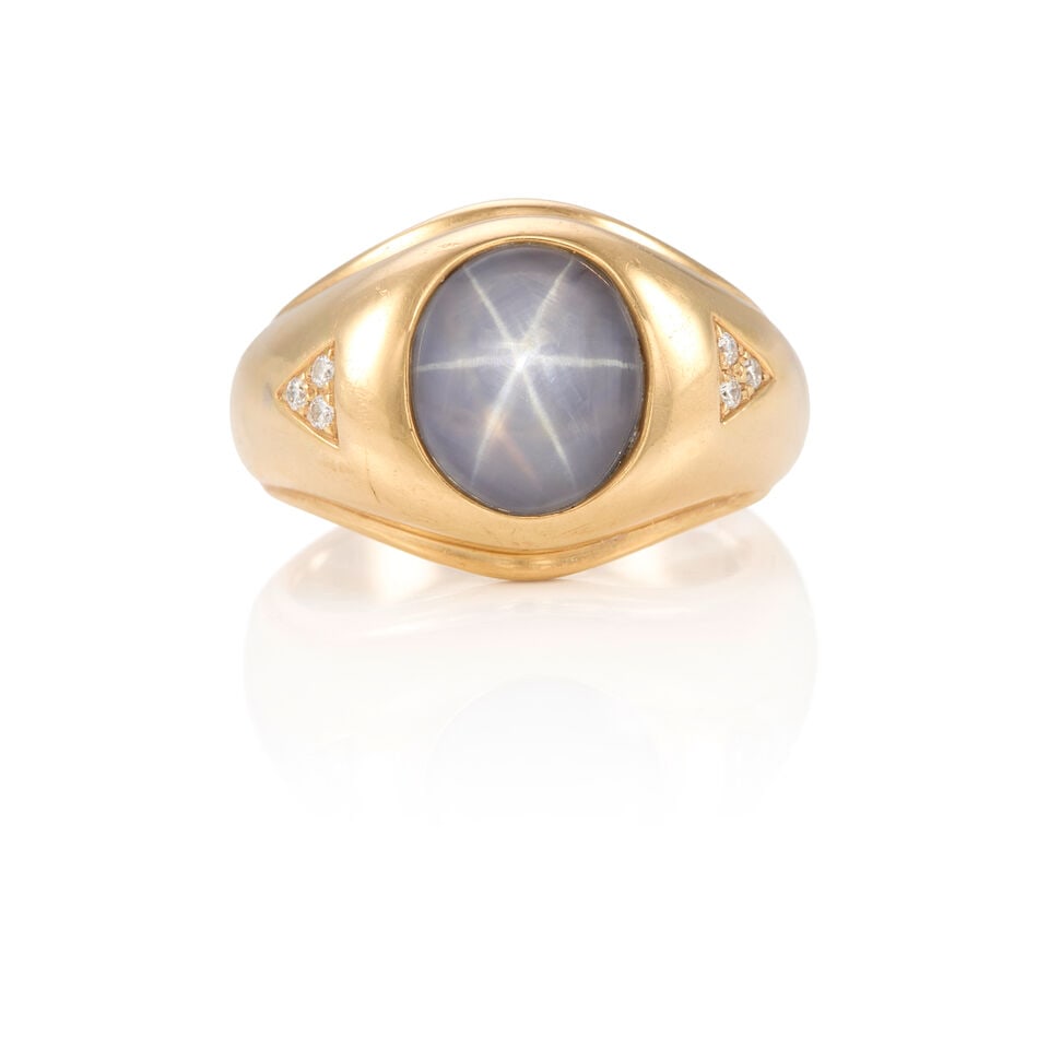 TREMONTI: 14K YELLOW GOLD, STAR SAPPHIRE, AND DIAMOND RING: TREMONTI: 14K YELLOW GOLD, STAR SAPPHIRE, AND DIAMOND RING • One oval cabochon star sapphire weighing approximately 4.25 carats • Six round diamonds weighing approximately 0.05 carat