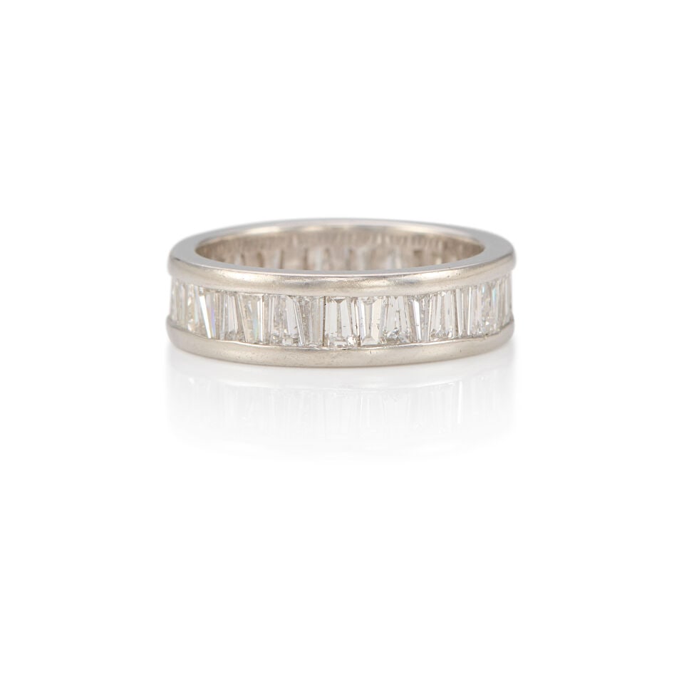 PLATINUM AND DIAMOND BAND RING: PLATINUM AND DIAMOND BAND RING • Numerous tapered baguette diamonds weighing approximately 1.95 carats total • Size 6 1/4 • Estimated gross weight 6.8 grams Footnotes: OVERALL CONDIT