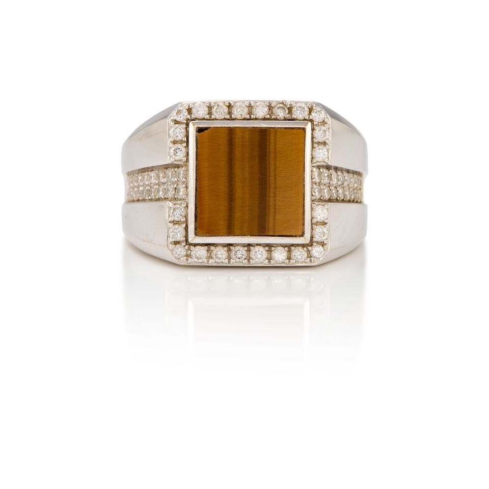 18K WHITE GOLD, TIGER'S EYE, AND DIAMOND RING: 18K WHITE GOLD, TIGER'S EYE, AND DIAMOND RING • One square shaped tiger's eye measuring approximately 10.22mm x 10.15mm x 1.68mm • Numerous round shaped diamonds weighing approximately