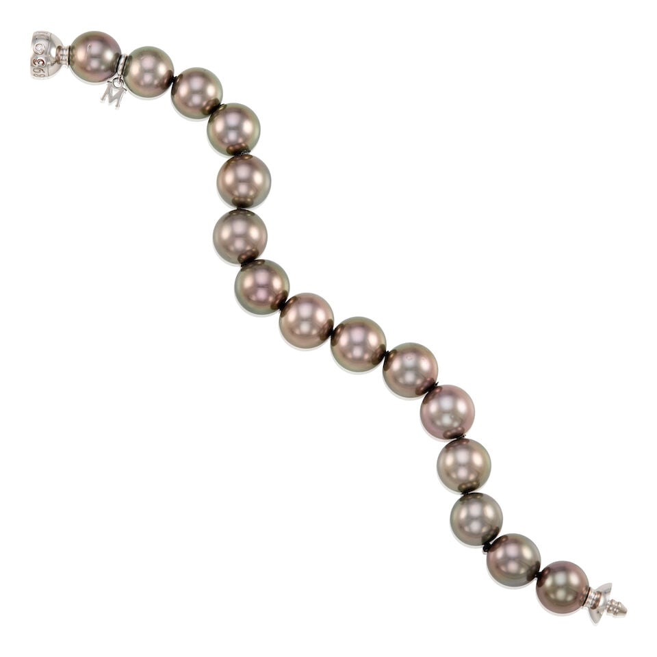 MIKIMOTO: 18K WHITE GOLD AND CULTURED PEARL BRACELET: MIKIMOTO: 18K WHITE GOLD AND CULTURED PEARL BRACELET • Numerous cultured pearls measuring approximately 11.80mm in diameter • One round shaped diamond on the clasp weighing approximately