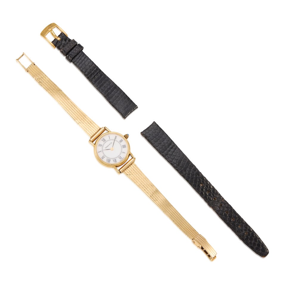 TIFFANY & CO.: 14K YELLOW GOLD WRISTWATCH WITH ADDITIONAL STRAP: TIFFANY & CO.: 14K YELLOW GOLD WRISTWATCH WITH ADDITIONAL STRAP • Dial and case back signed TIFFANY & CO., with serial number • Quartz movement, currently not working and accurate