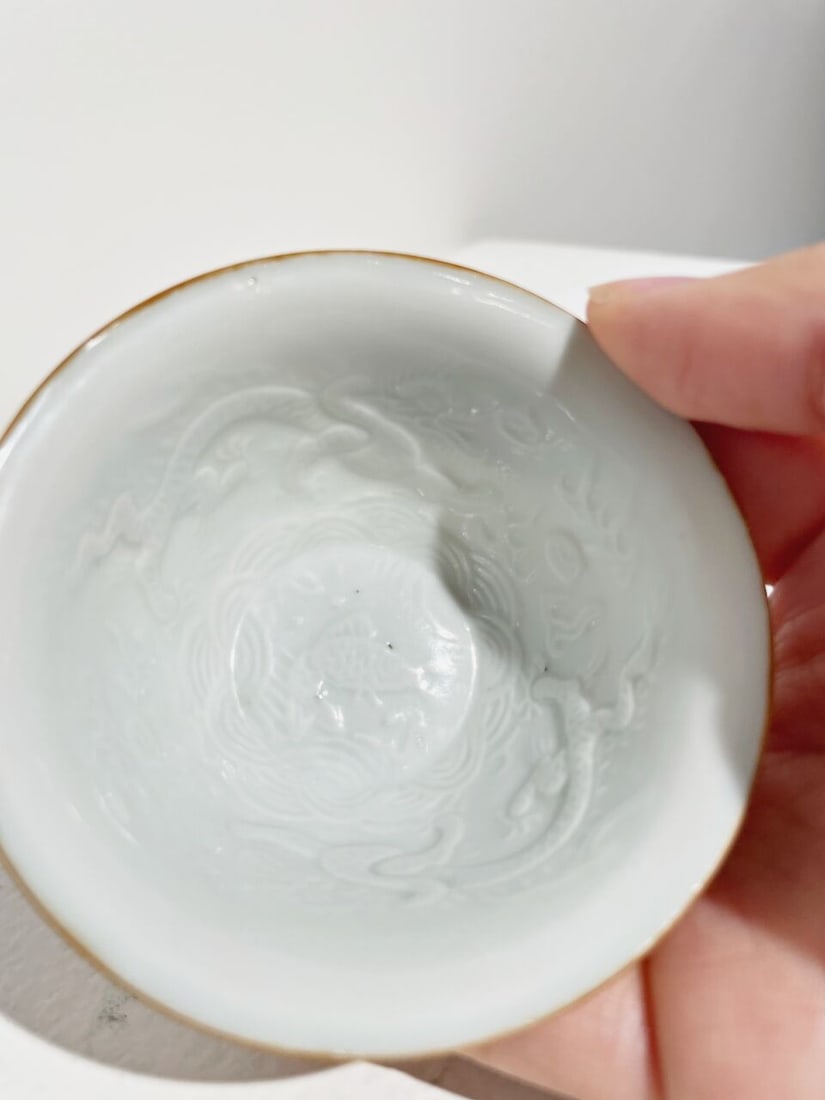 A WHITE-GLAZED MOULDED 'DRAGON AND CARP' CUP Transitional Period - 5