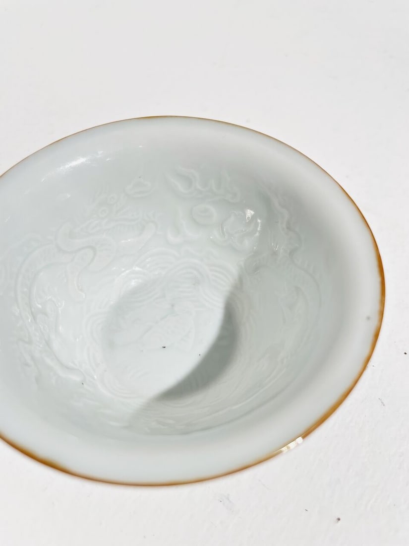 A WHITE-GLAZED MOULDED 'DRAGON AND CARP' CUP Transitional Period - 6