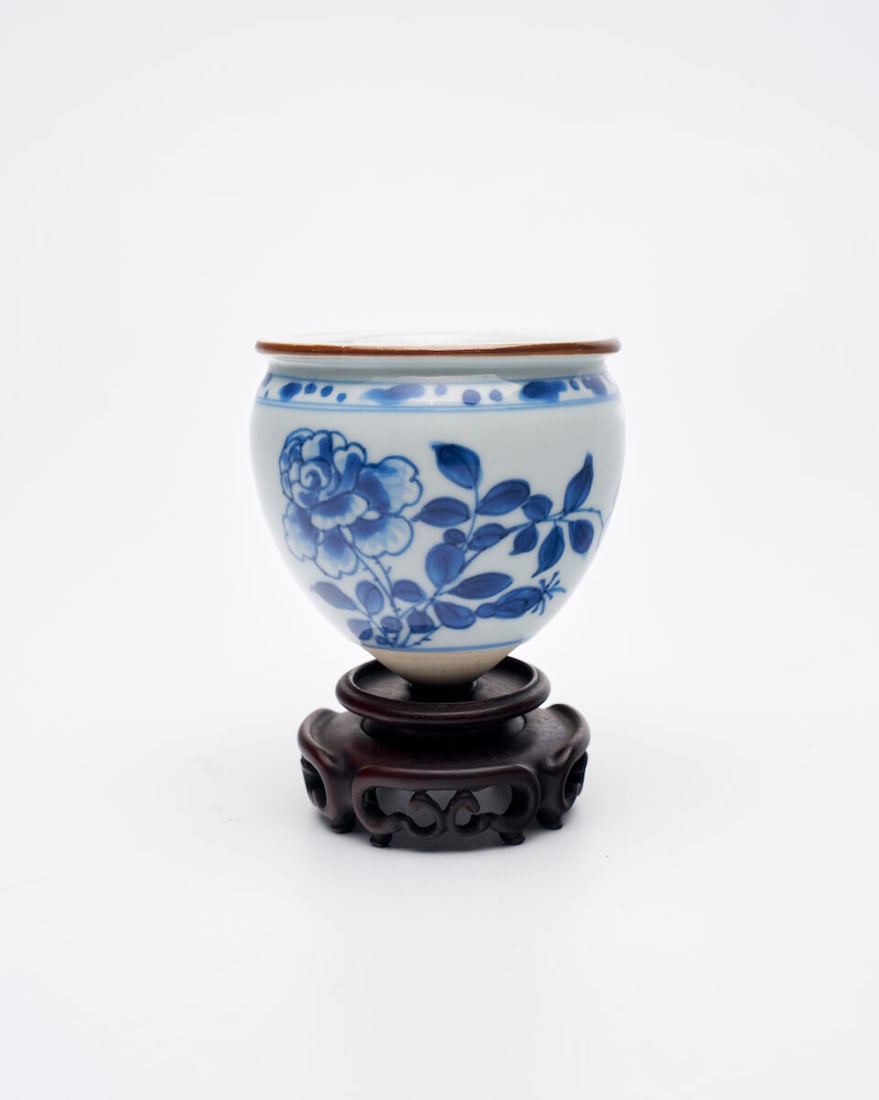 A BLUE AND WHITE 'FLORAL' BOWL FOR A STEM CUP Transitional Period: A BLUE AND WHITE 'FLORAL' BOWL FOR A STEM CUP Transitional Period 7.7cm high Footnotes: Provenance: The Gladys Shead collection R&V Tregaskis Oriental Art, Sydney, number '1358' (label and