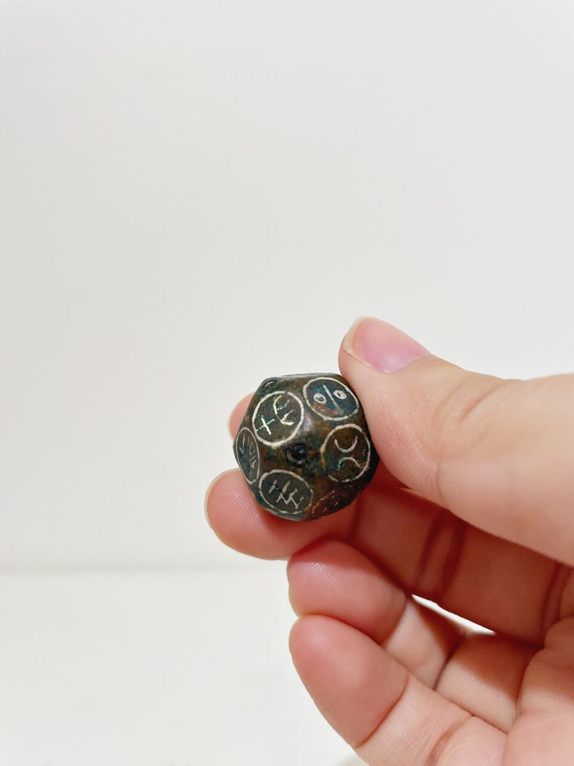 A BRONZE DICE WITH SILVER INLAYS - 2