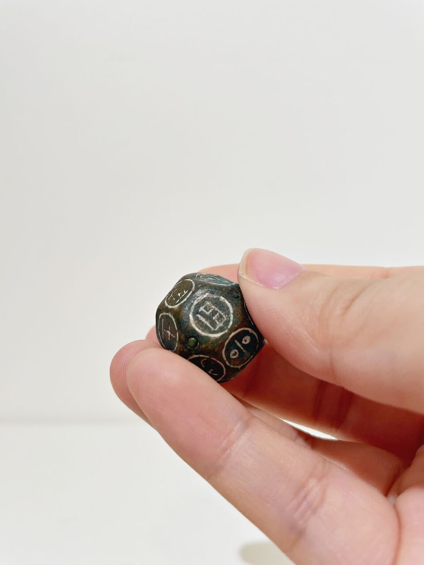 A BRONZE DICE WITH SILVER INLAYS - 3