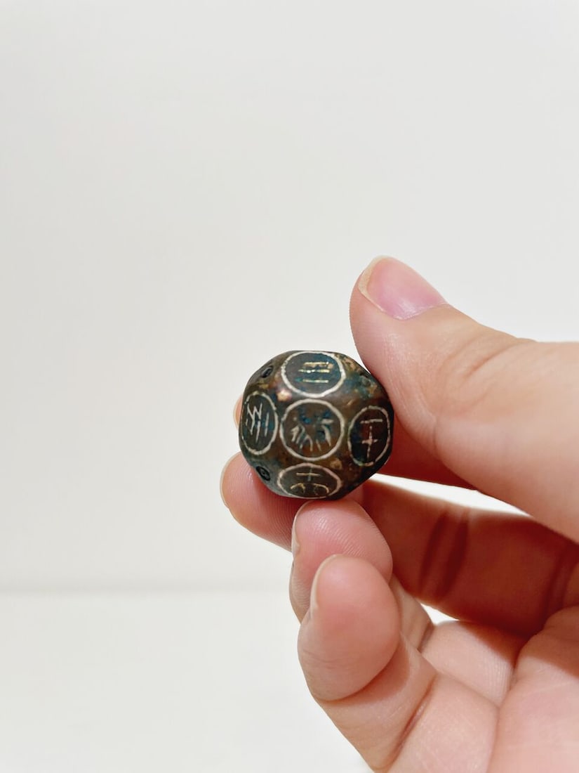 A BRONZE DICE WITH SILVER INLAYS - 4
