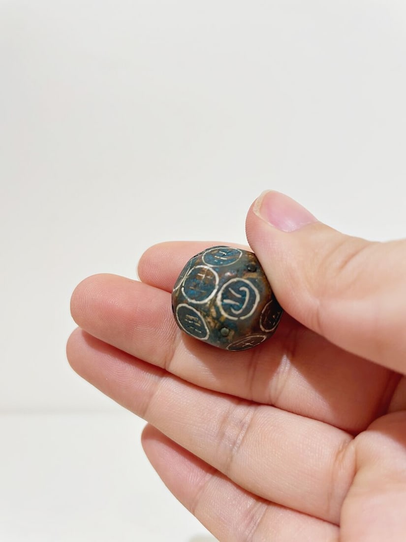 A BRONZE DICE WITH SILVER INLAYS - 5