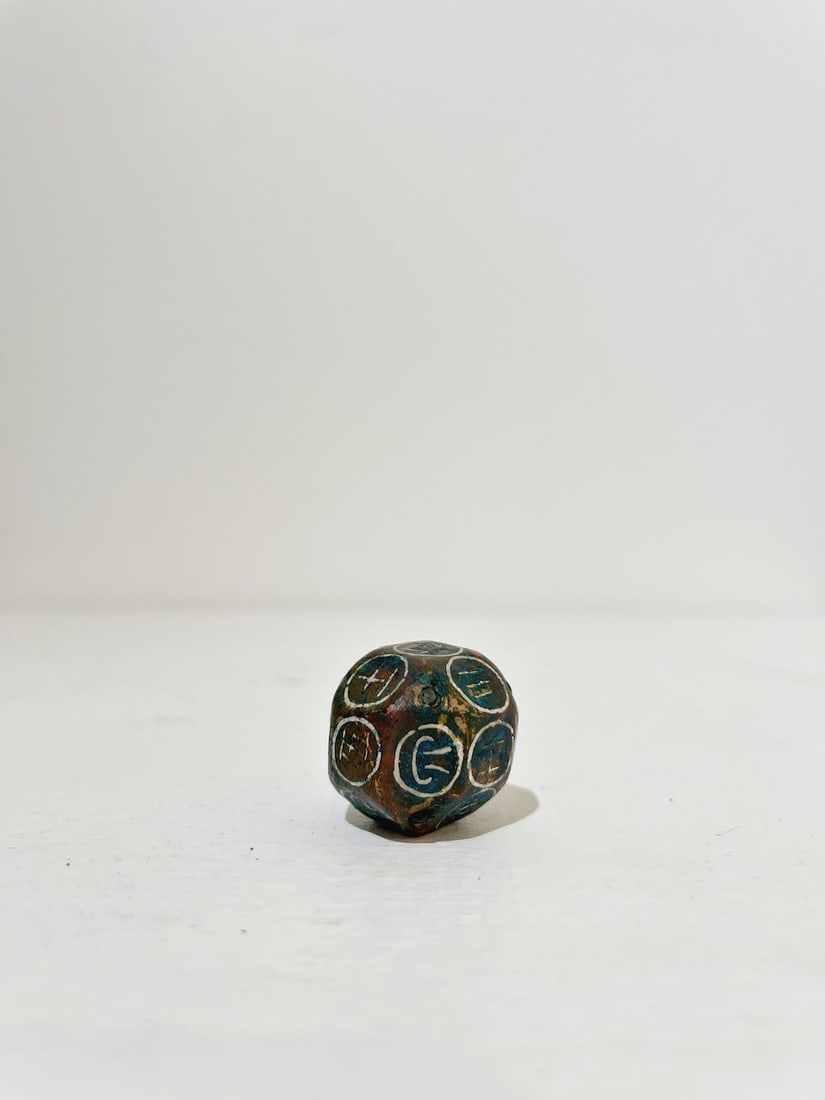 A BRONZE DICE WITH SILVER INLAYS - 6