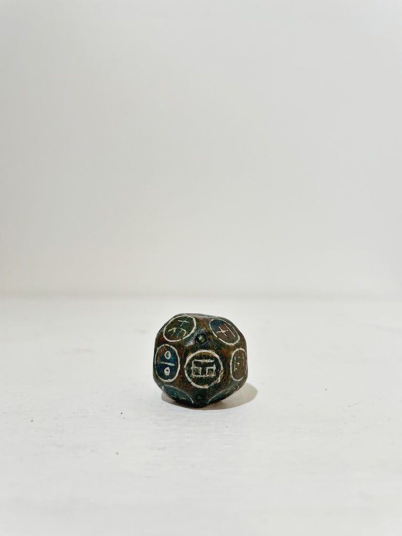 A BRONZE DICE WITH SILVER INLAYS - 7
