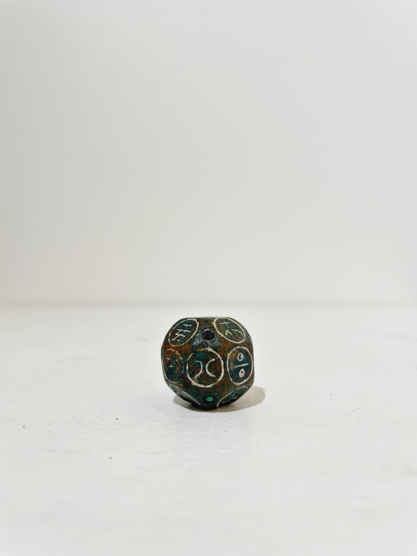 A BRONZE DICE WITH SILVER INLAYS - 8