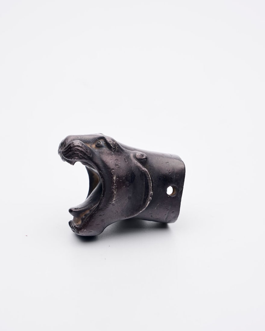 A SILVER ALLOY 'TIGER' ACCESSORY: A SILVER ALLOY 'TIGER' ACCESSORY 4.1cm long Footnotes: 銀合金虎頭飾件 For further information on this lot please visit Bonhams.com For further information